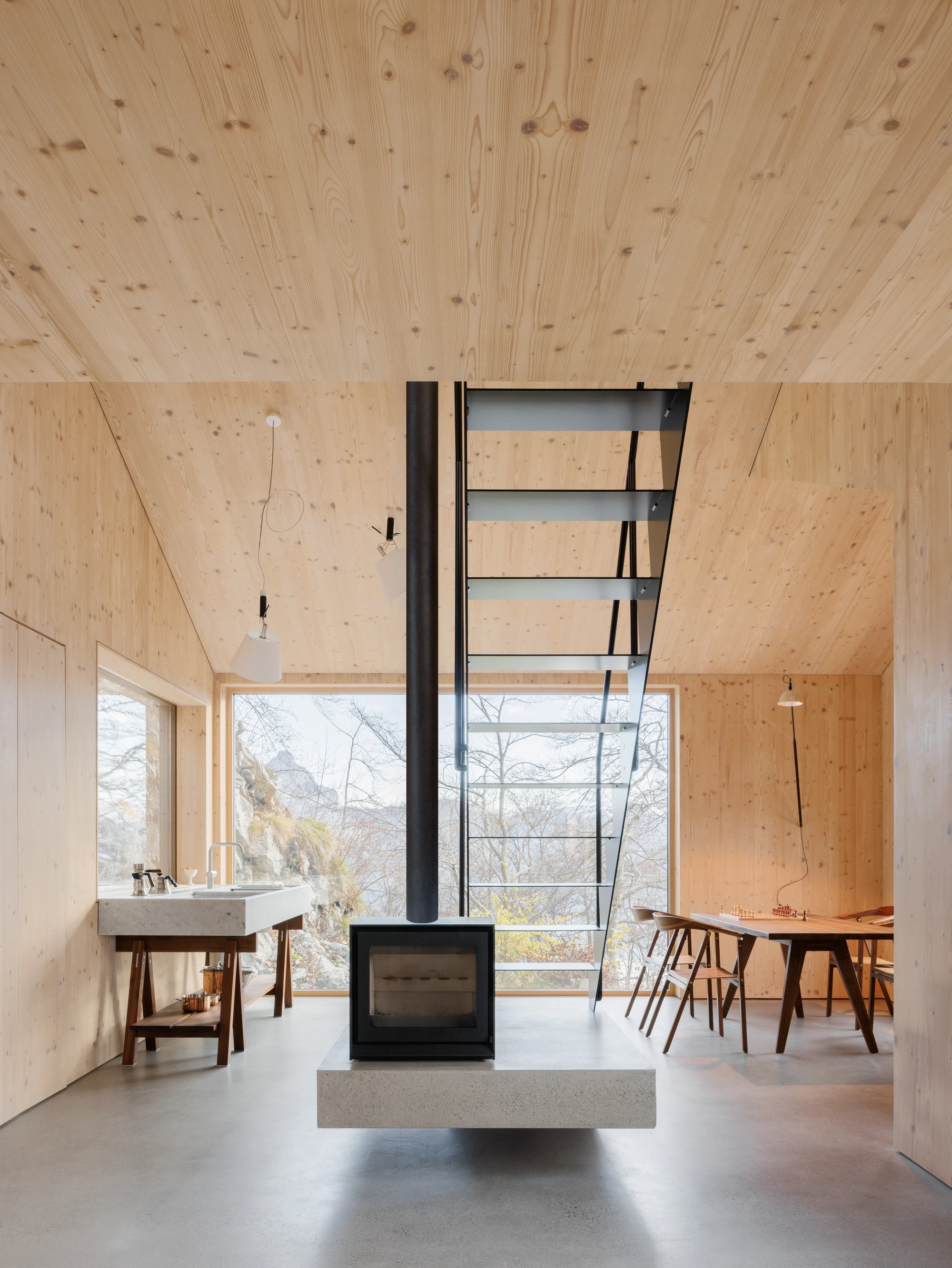 Swiss Alpine Cabin Reconstruction by Guča arch., photographed by Matej Hakár — Exterior close-up of the stone cladding at the base of the structure: coursed local stone with tight joints, the rough plaster wall joining above.