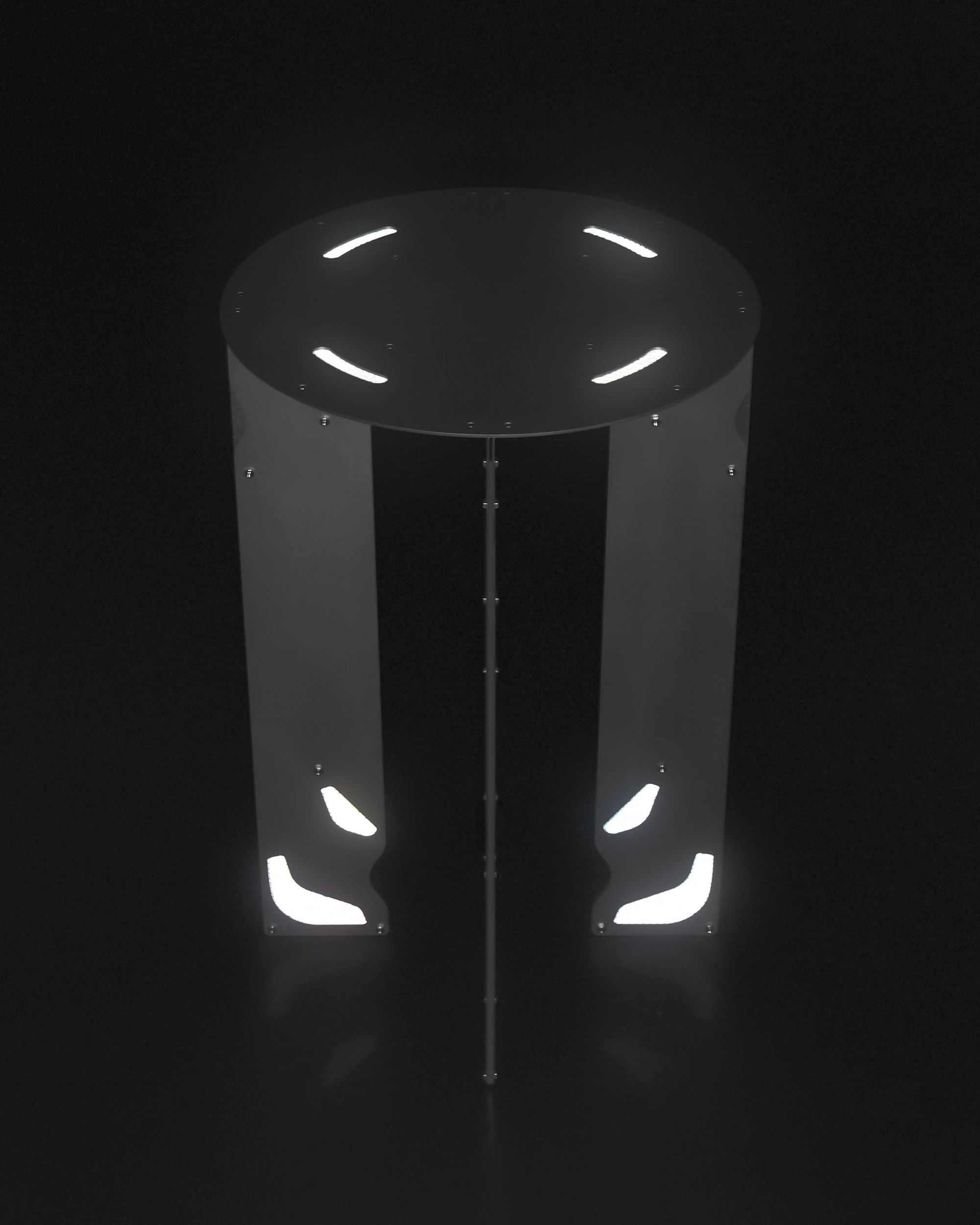 Retroreflective Stool by A POW STUDIO, photographed by hyunbeom Lee — Side view of the lower stool variant: aluminium legs at reduced height, the shaped apertures in the plate visible, the retroreflective edge bright against grey.