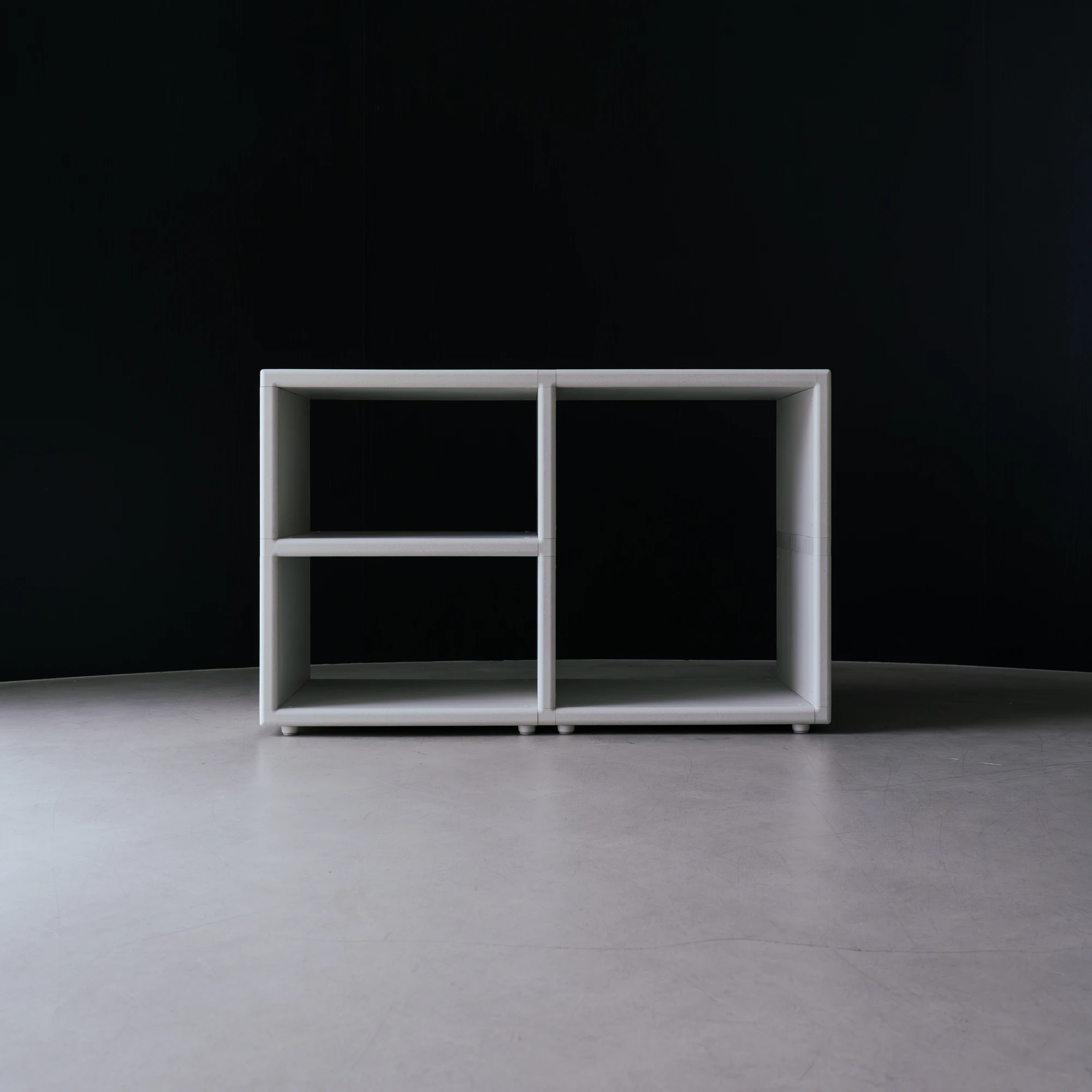 reol: Modular Narratives in Recycled Plastic by reol — Wider view of the reol system in a domestic-scale space: multiple units configured as a shelving cluster, the glass-block wall partition in the background.