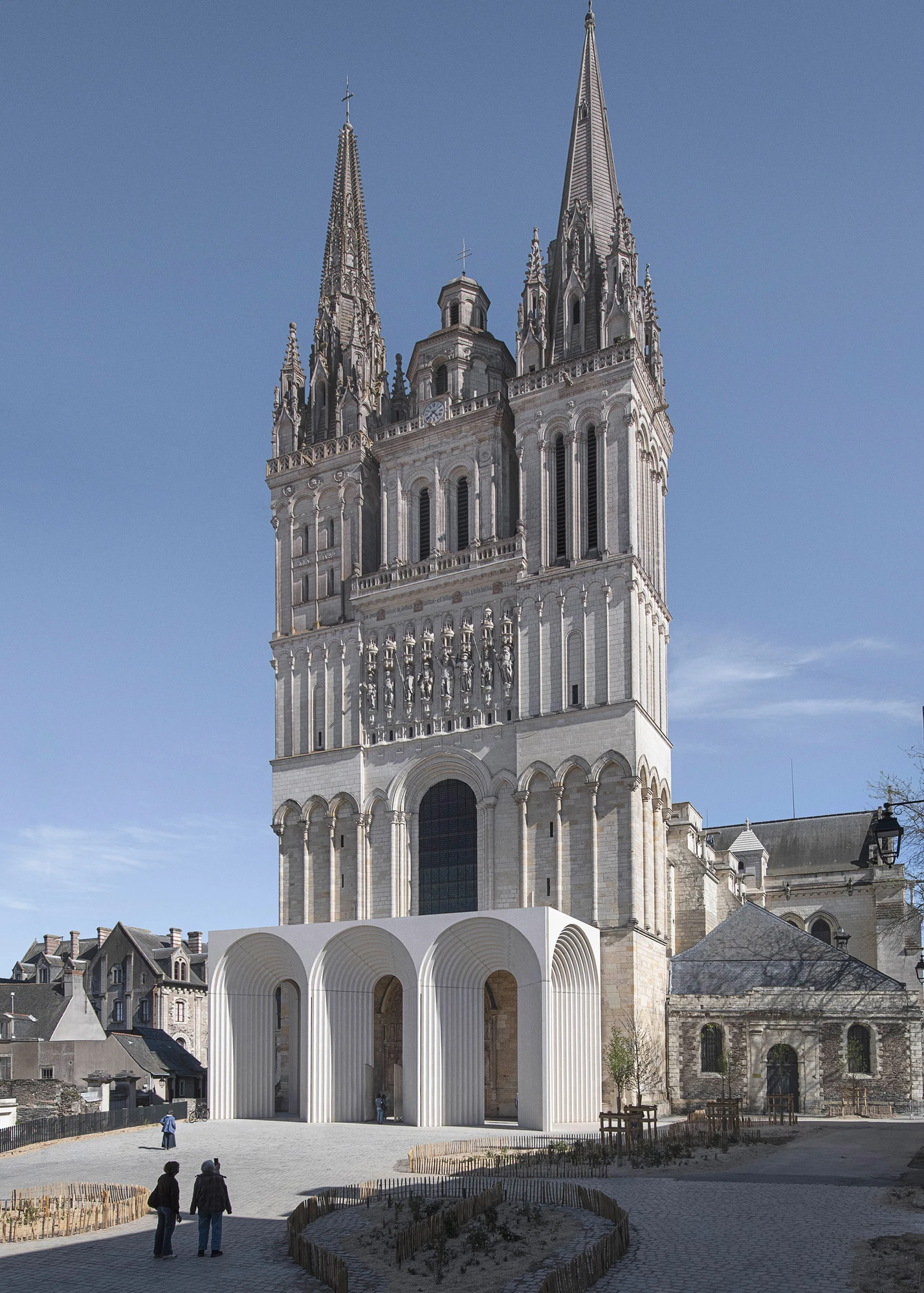 Angers Cathedral Entrance by Kengo Kuma and Associates — Wide view of the cathedral from the public square under overcast sky, the concrete entrance gallery spanning the full width of the Gothic facade's base with five arches.