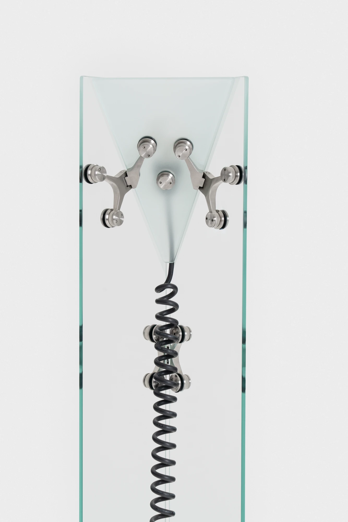 Ferric Glass by Tino Seubert, photographed by Piercarlo Quecchia, DSL Studio — Collection overview at the Delvis show: the TV cabinet and smaller pieces together, the full range of hinge deployments visible across the pieces.