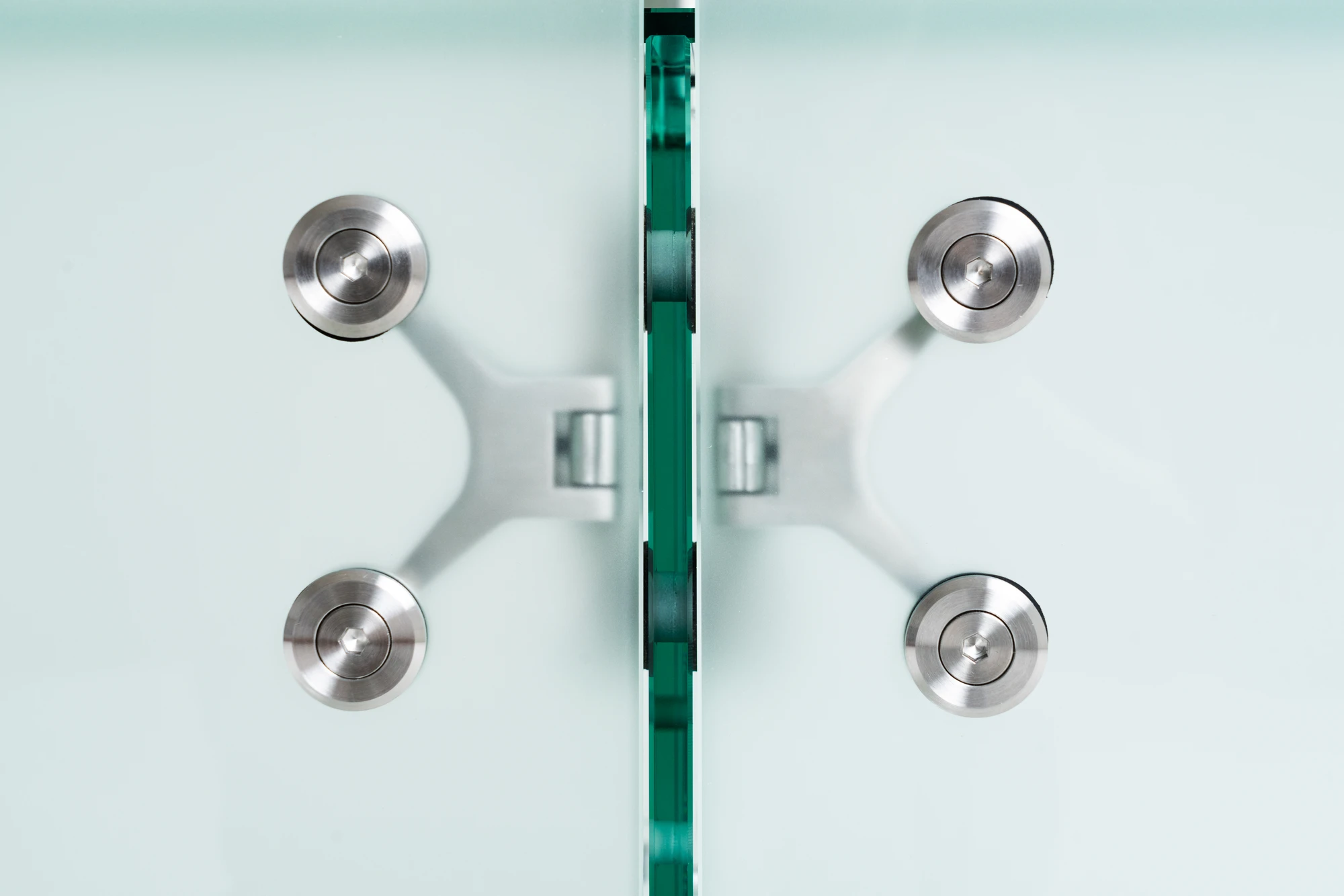 Ferric Glass by Tino Seubert, photographed by Piercarlo Quecchia, DSL Studio — Wide shot in the Delvis Unlimited show context: sideboard and other Ferric Glass pieces shown together, industrial glass and stainless hardware against white walls.