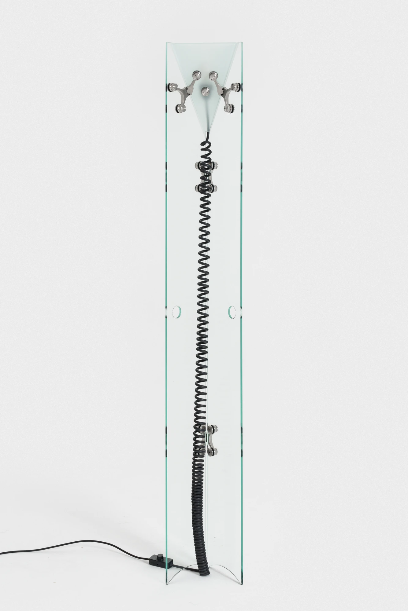 Ferric Glass by Tino Seubert, photographed by Piercarlo Quecchia, DSL Studio — Ferric Glass floor lamp at full height: glass panels and spider hardware visible along the length, the green tint of the high-iron material at every cut surface.
