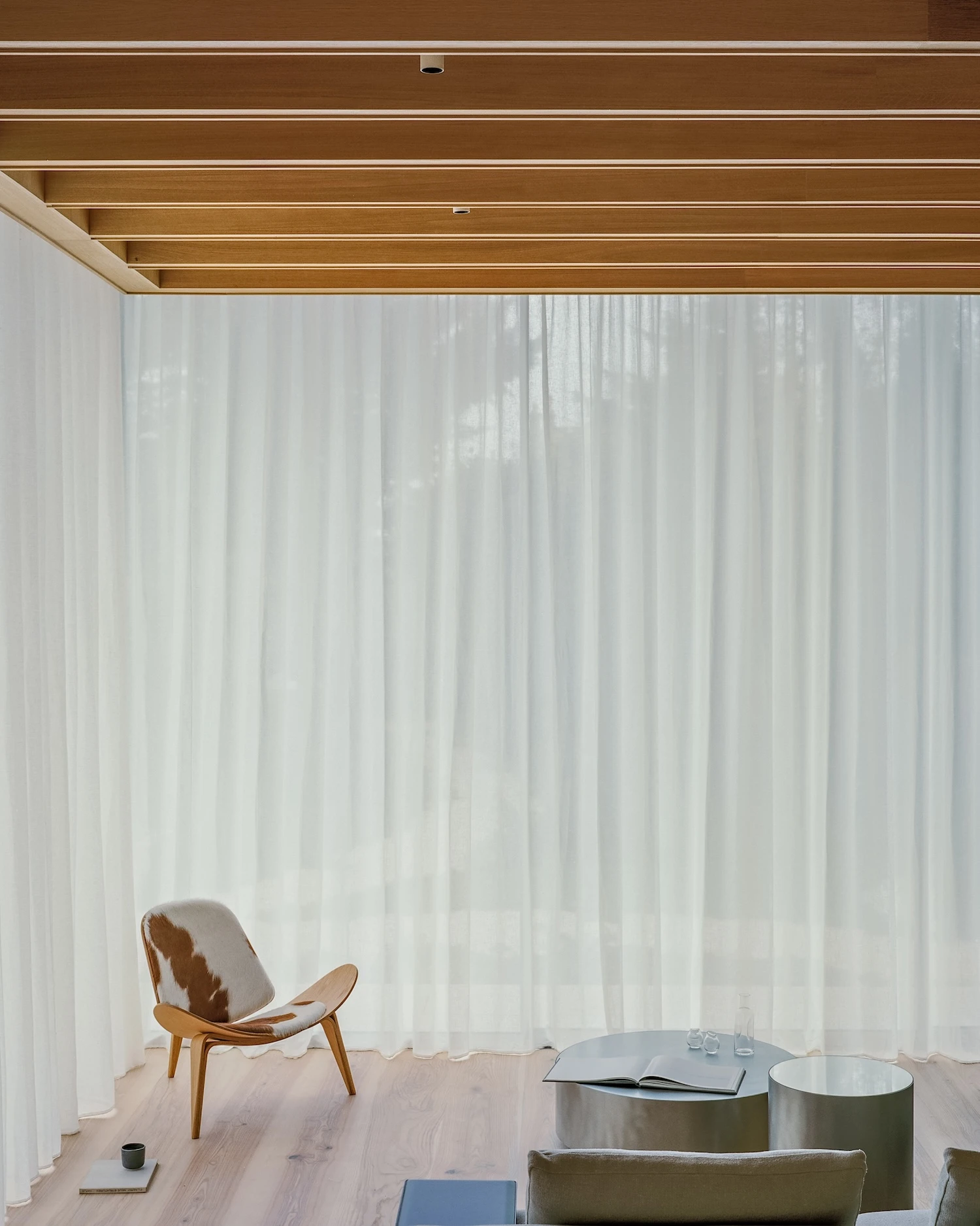 Panoramic House by MATA Architects, photographed by Nick Dearden — Bathroom detail: a solid oak ofuro bath with box-jointed corners and wall-mount fittings, placed before a wall of fine white ribbed ceramic tile.
