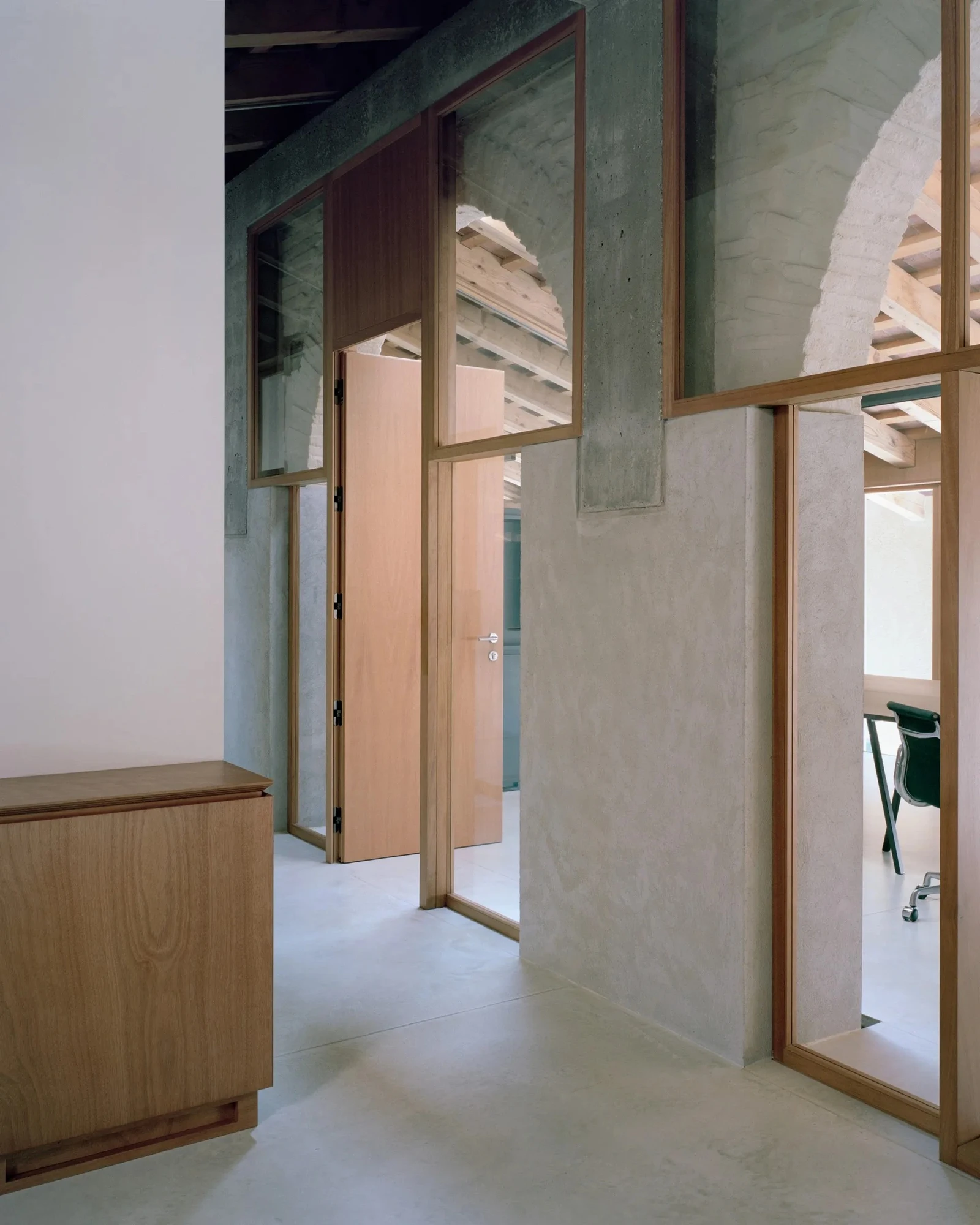 Vis-à-vis Restoration of Villa Doná and Barchessa by RigonSimonetti, photographed by Rory Gardiner, Alberto Sinigaglia — Ground floor coworking space: exposed brick columns, timber floor, forest-green steel partitions, the colonnade loggia visible…