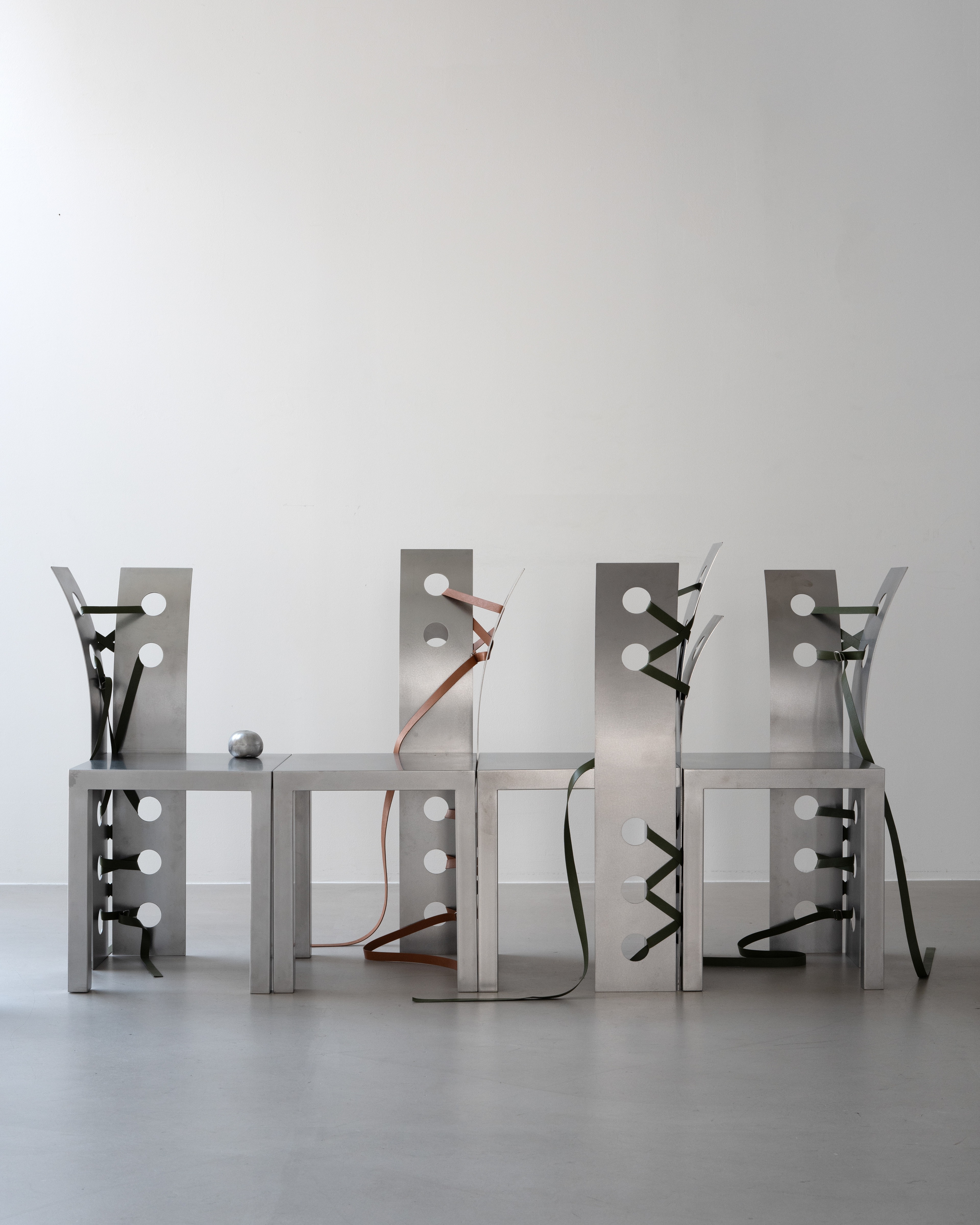 Pul Collection by Nara Lee, photographed by Namuk Kim — The Sun Room installation: multiple pieces in a high-ceilinged room with directed lighting, steel surfaces catching pooled warm light.