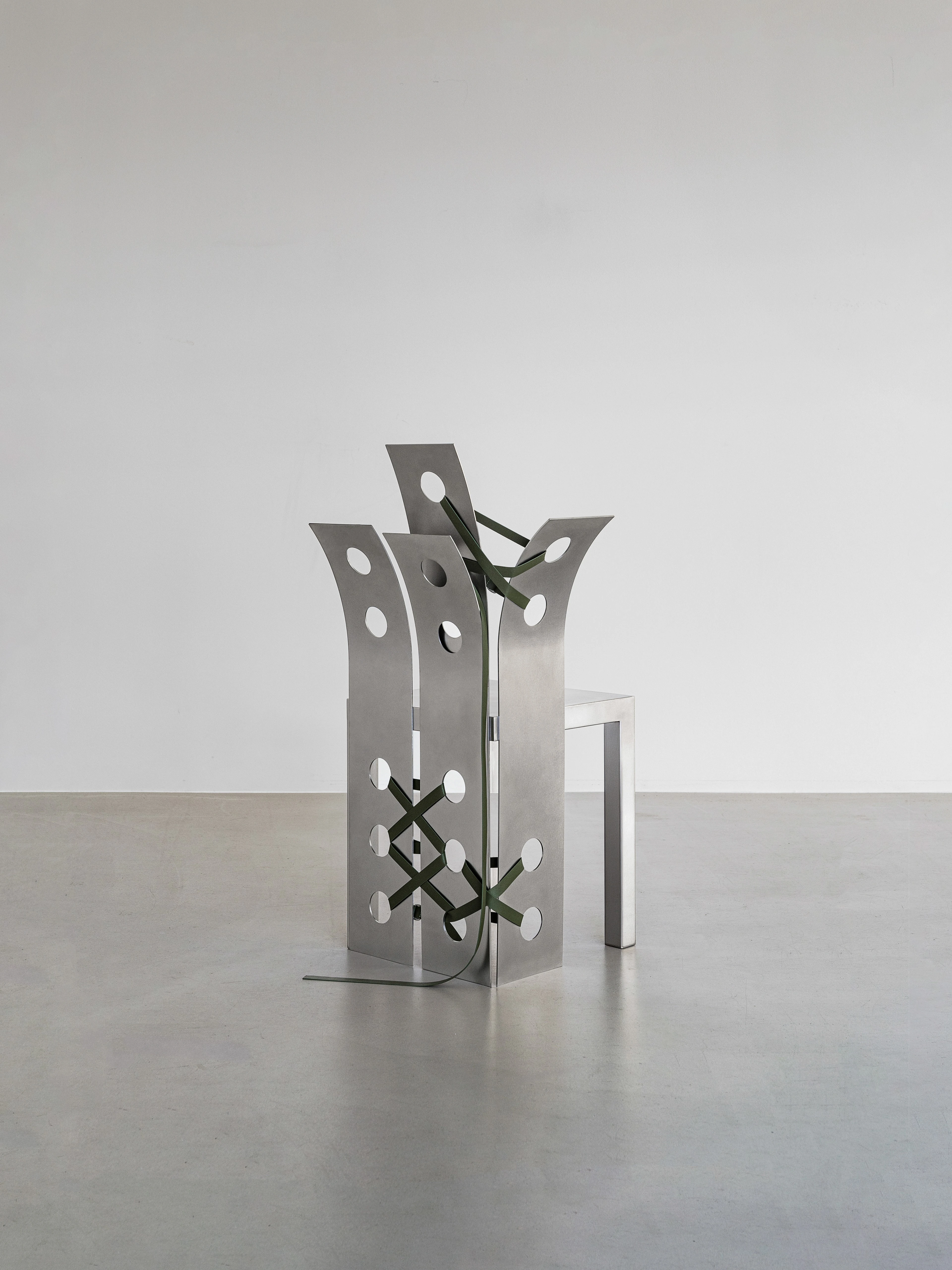 Pul Collection by Nara Lee, photographed by Namuk Kim — Two folding screens framing an open passage in the exhibition space, a chair with tan lacing visible between them.