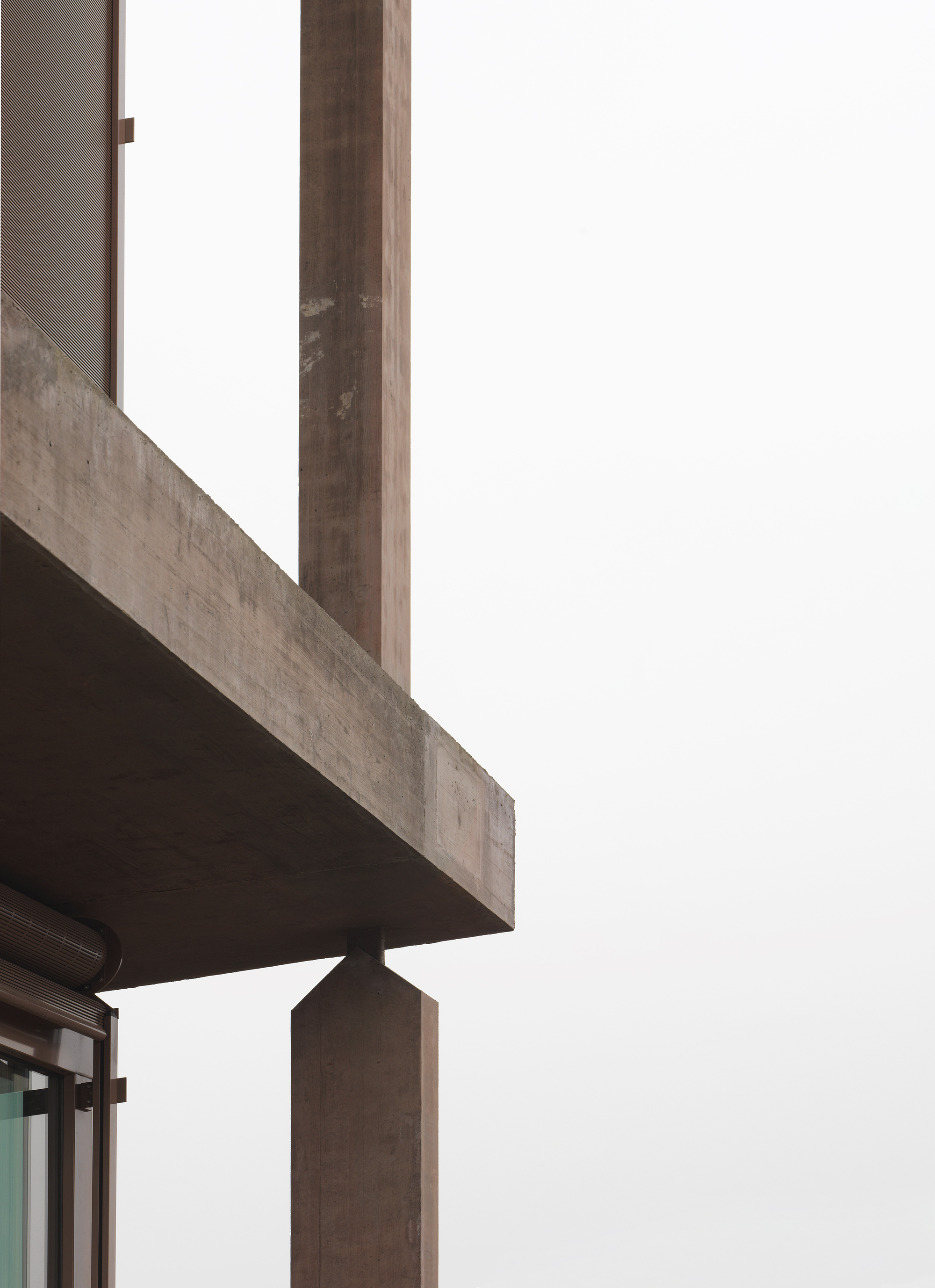 Baloise Insurance Company Office Tower by Valerio Olgiati, photographed by Bas Princen — Concrete column-to-slab connection isolated against white fog, the joint revealing the house profile and weathered formwork texture.