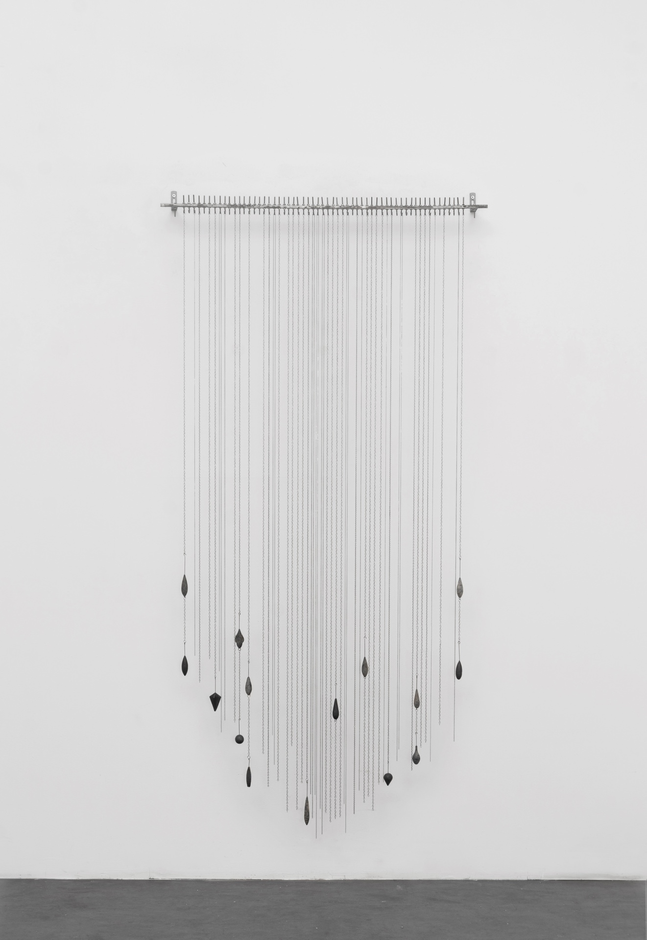 Main de fer, gant de velours by Agurto + Fiedler, photographed by Katherinne Fiedler — Garúa by Katherinne Fiedler, stainless steel chains descending from horizontal bar, varied lead weights pulling lines at staggered heights.
