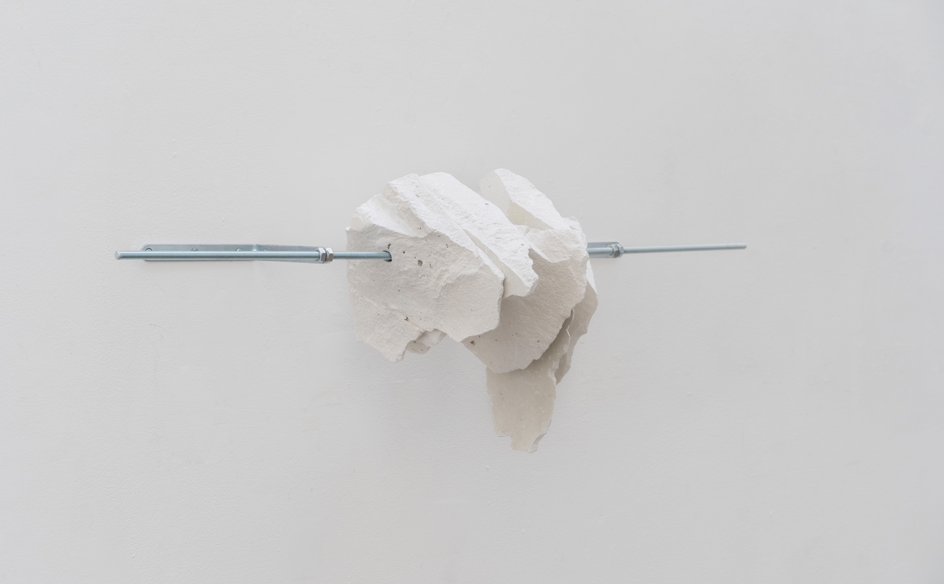 Main de fer, gant de velours by Agurto + Fiedler, photographed by Katherinne Fiedler — L'Enveloppe-cœur by Marinés Agurto, clustered plaster fragments pierced horizontally by zinc threaded rod with hex nuts at both ends.