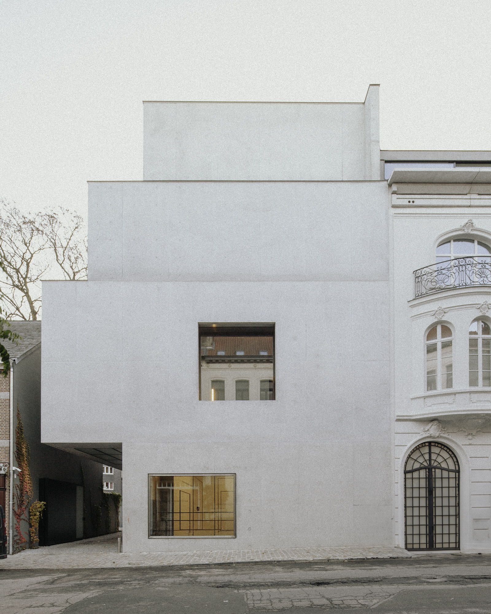 Xavier Hufkens Gallery by Robbrecht en Daem Architecten, photographed by Jeremy Piret — Architectural section drawing showing stacked concrete volumes stepping back from the historic maison de maître, zenithal openings at each level.