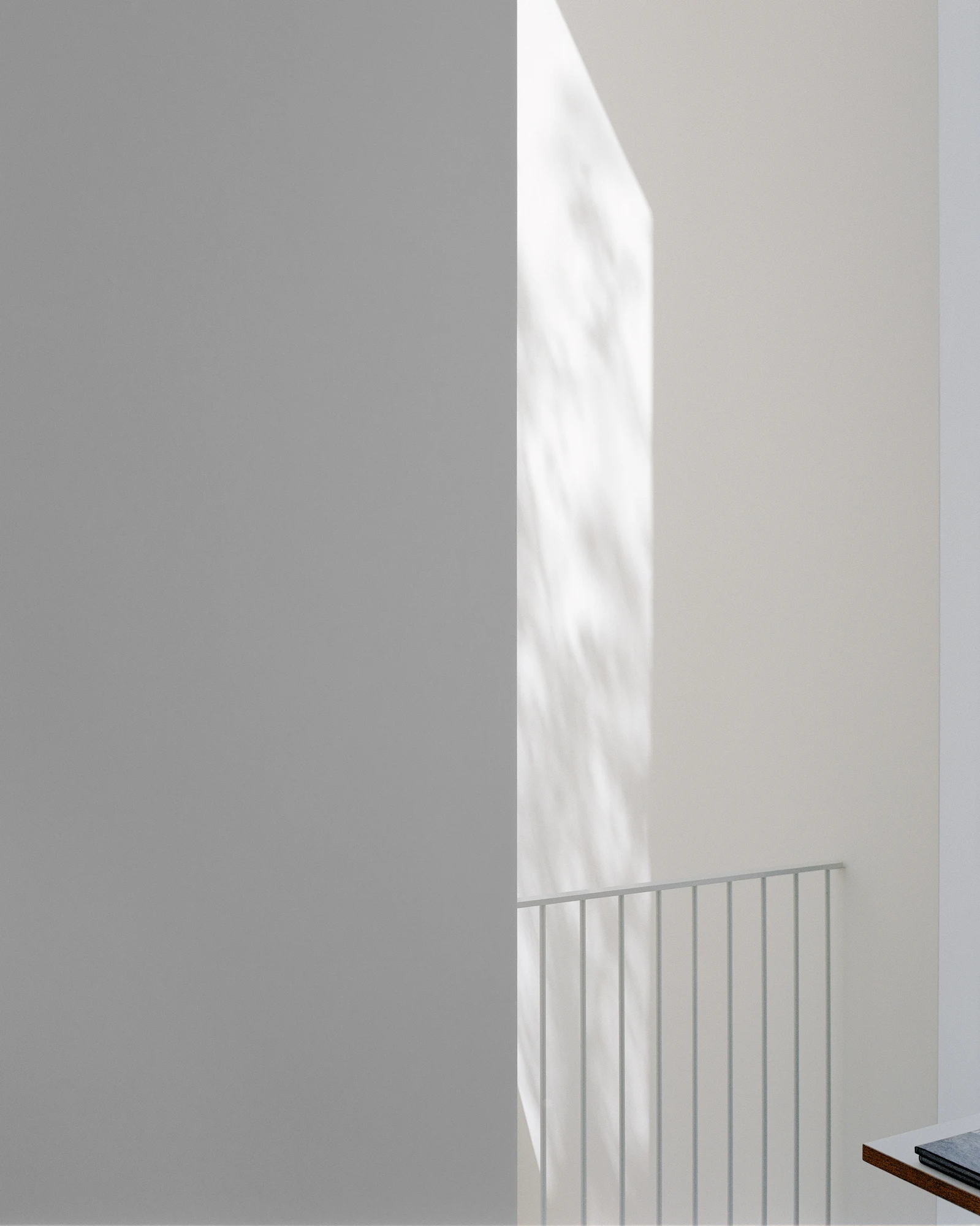 Bastian Gallery by John Pawson, photographed by Julian Holzwarth — Interior corner detail: grey plaster meets the edge of a full-height opening; dappled tree shadow crosses the upper wall as a thin steel railing defines the lower limit of the glazing.