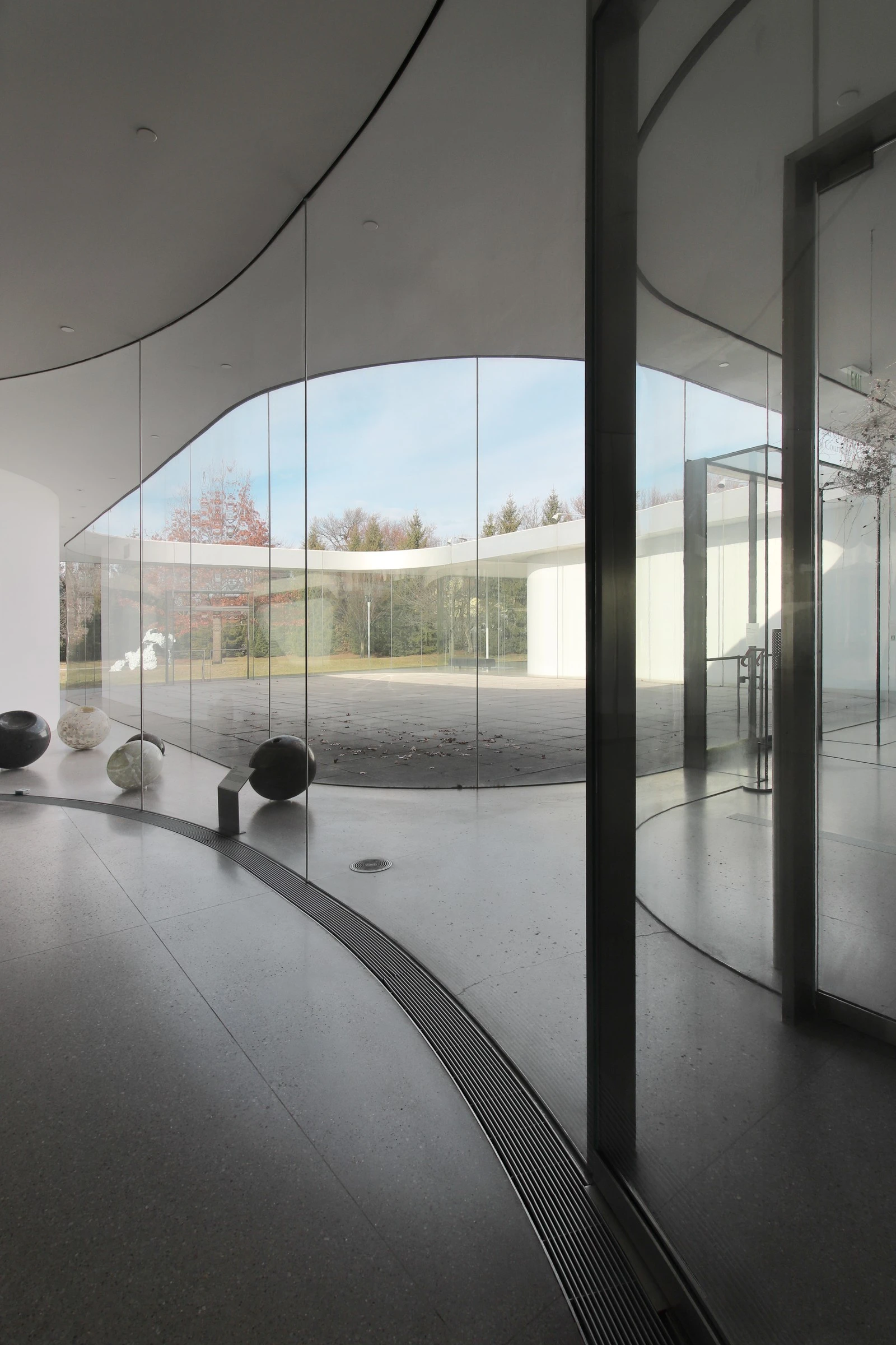 Toledo Museum Glass Pavilion by SANAA, Toledo Ohio USA, curved low-iron laminated glass, double-skin envelope, hot shop gallery adjacency, photographed by Trevor Patt