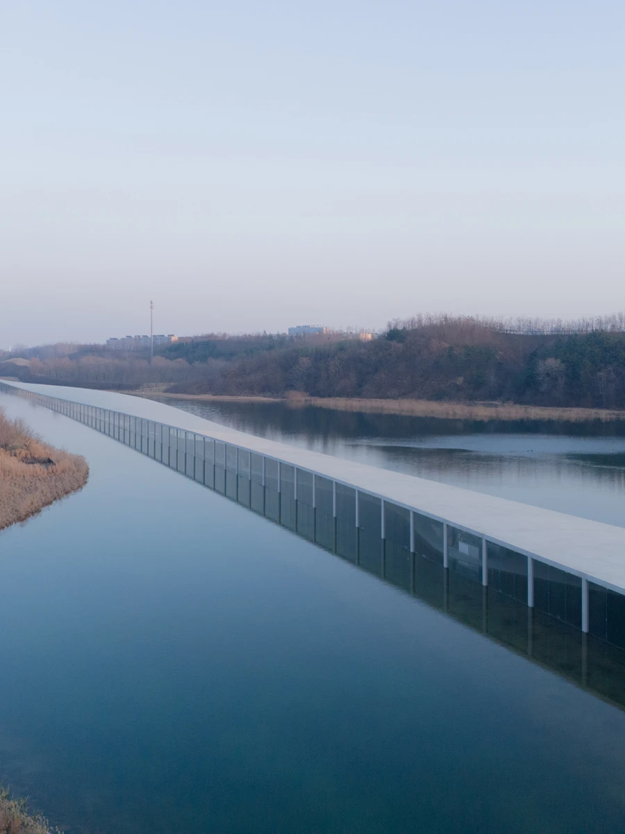 Zaishui Art Museum by junya ishigami + associates, Rizhao Shandong China, one kilometre long, lake, slender columns in water, sash roof, photographed by arch-exist