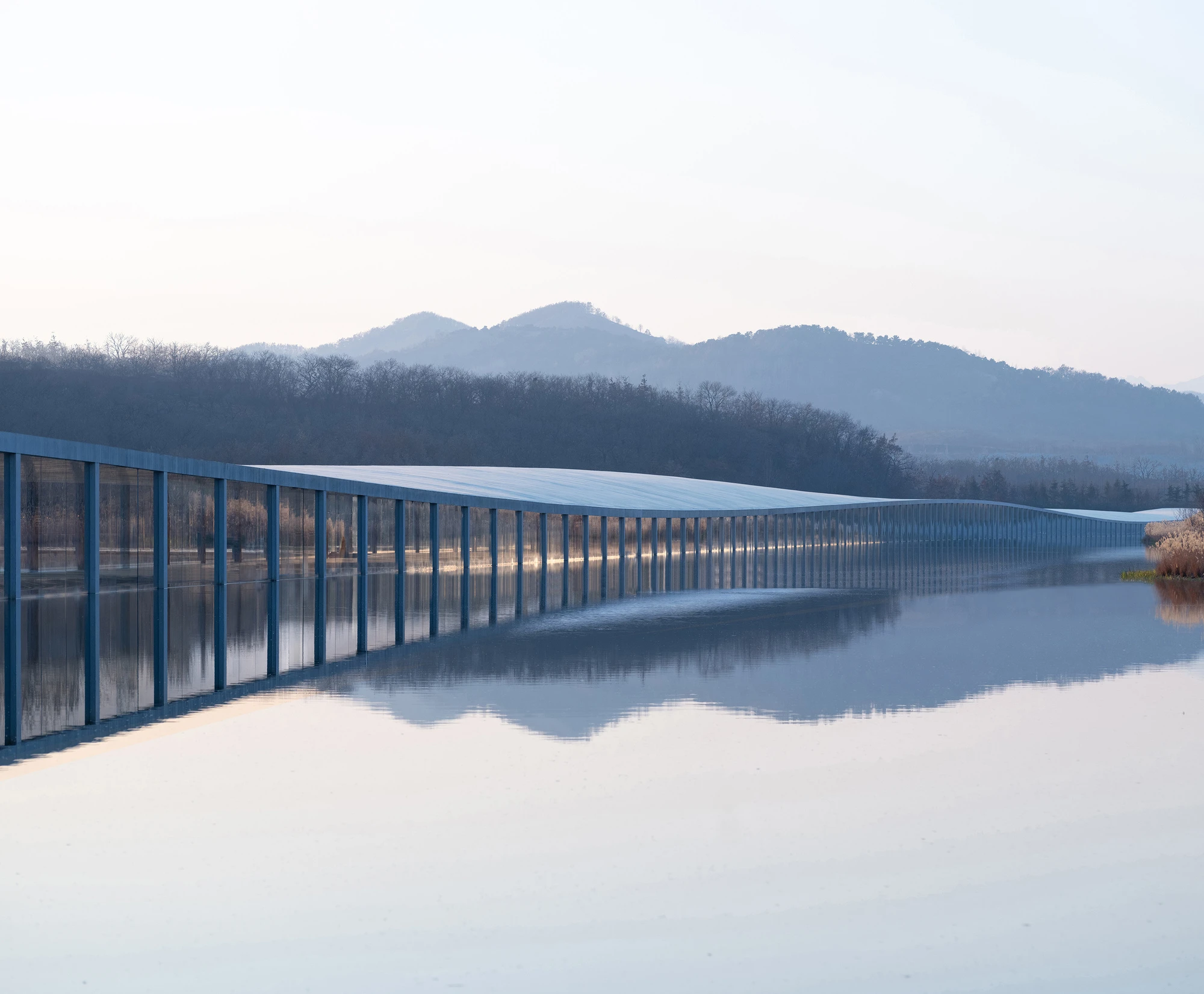 Zaishui Art Museum by junya ishigami + associates, Rizhao Shandong China, one kilometre long, lake, slender columns in water, sash roof, photographed by arch-exist