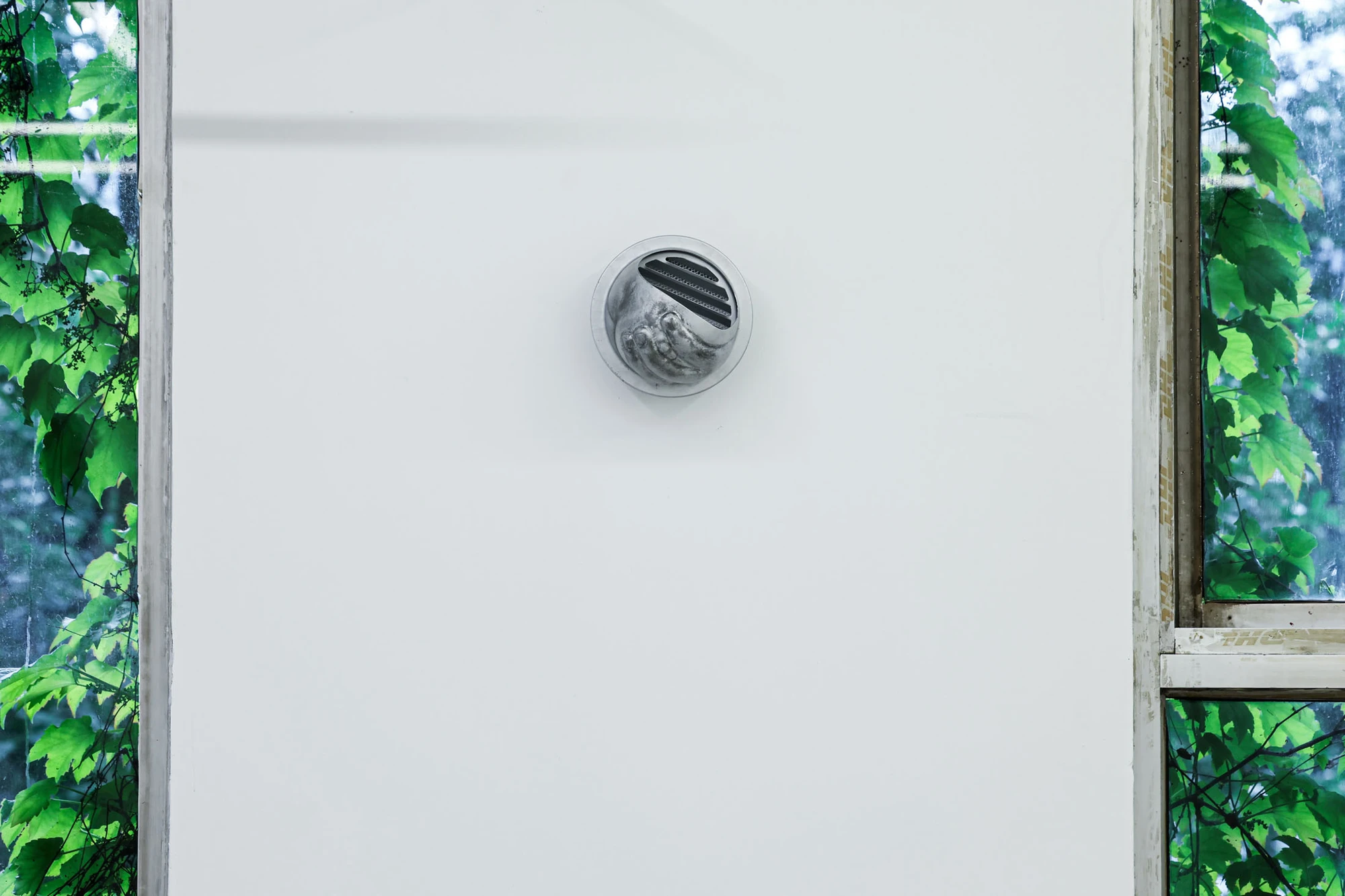 A User Guide by Tian Jianxin, photographed at Capsule — kettles, a fuel canister, and a small wire hanger arrange themselves across cinder-block plinths in raking afternoon light.