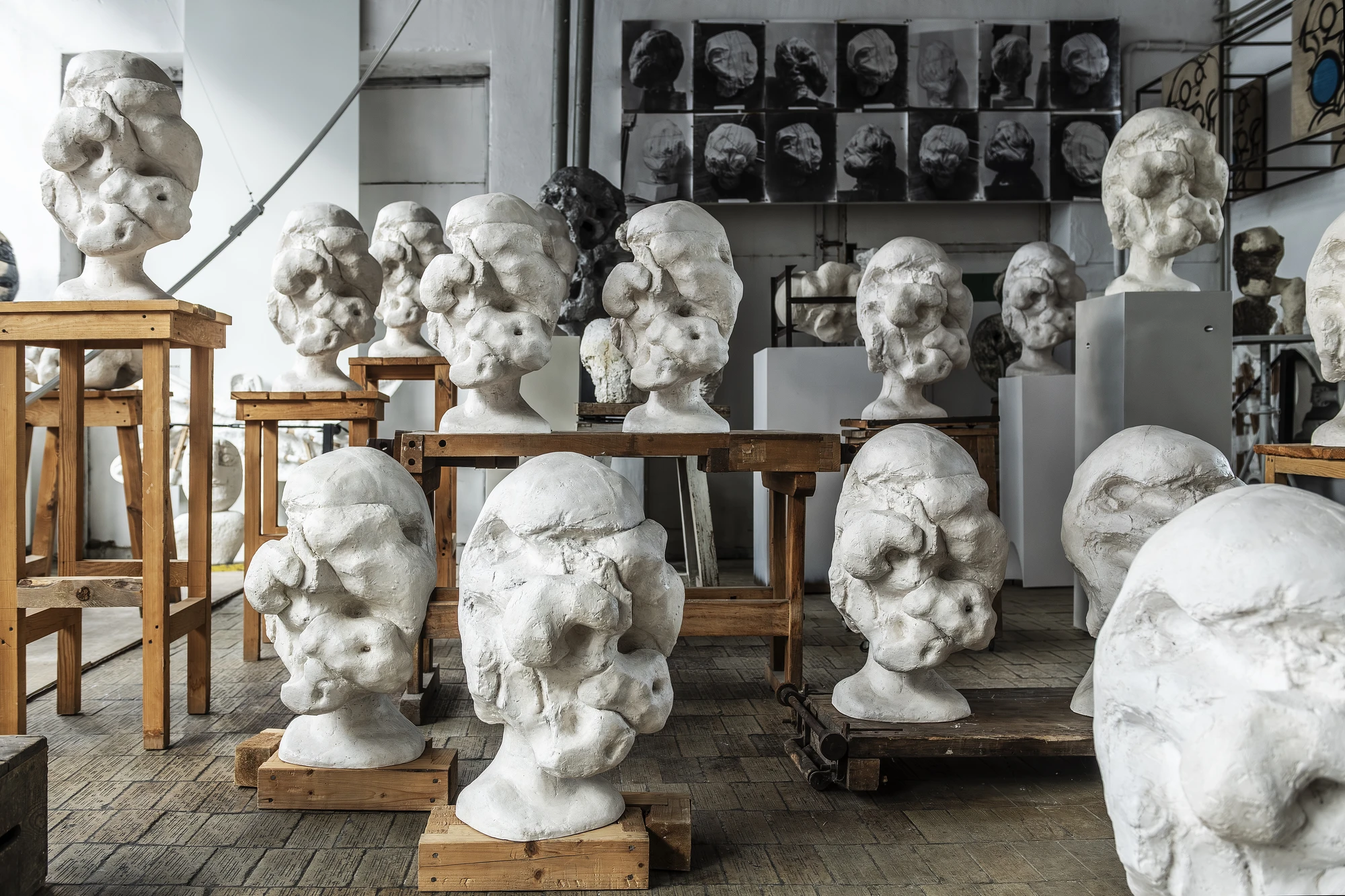 Magdalena Abakanowicz / Wanda Czełkowska by Abakanowicz Foundation, photographed by Norbert Piwowarczyk — Czełkowska's heads in the background, Abakanowicz's hollow plaster legs in the foreground.