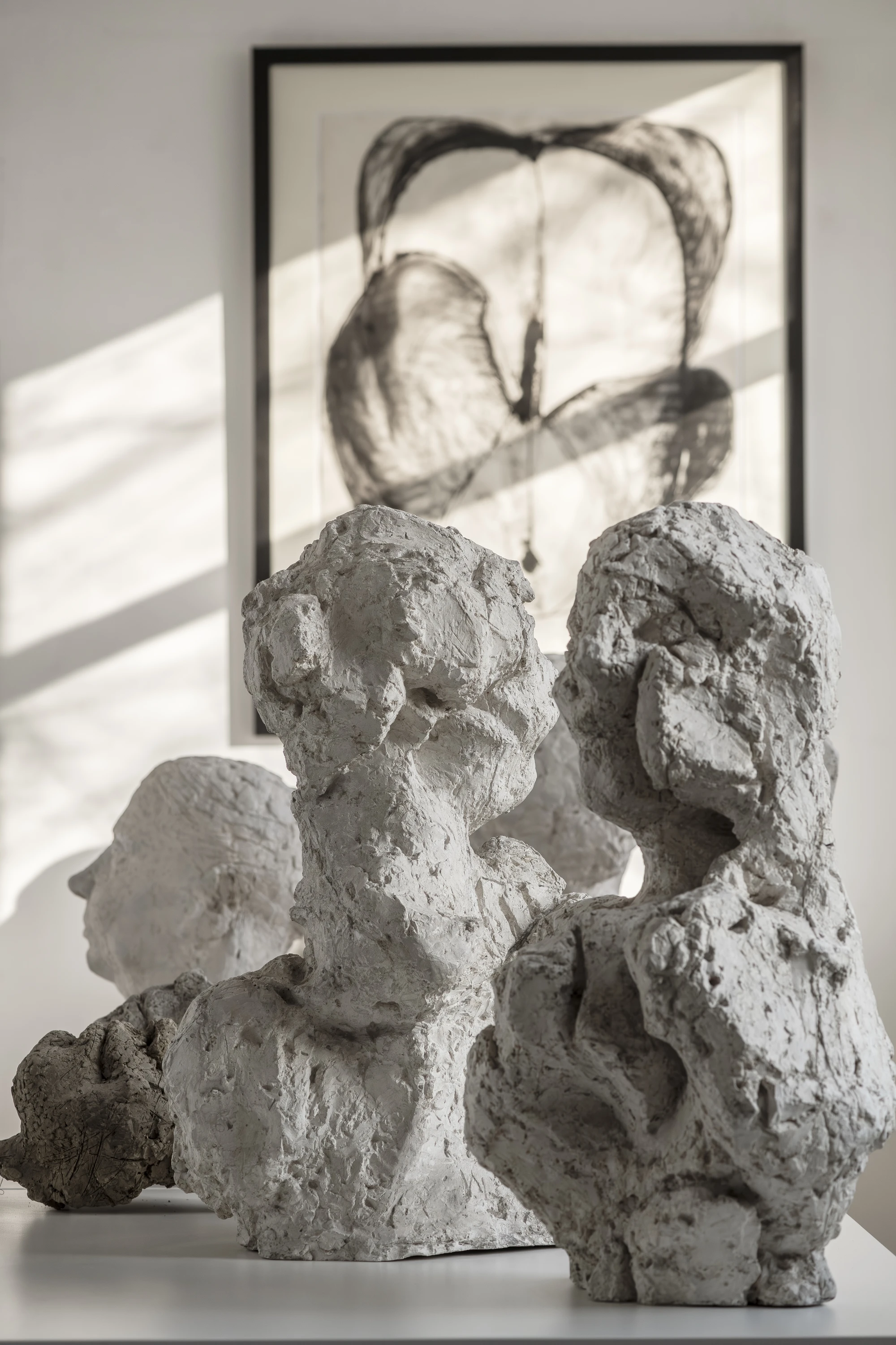 Magdalena Abakanowicz / Wanda Czełkowska by Abakanowicz Foundation, photographed by Norbert Piwowarczyk — close view of plaster torsos arranged shoulder to shoulder, wooden interior supports exposed at their base.