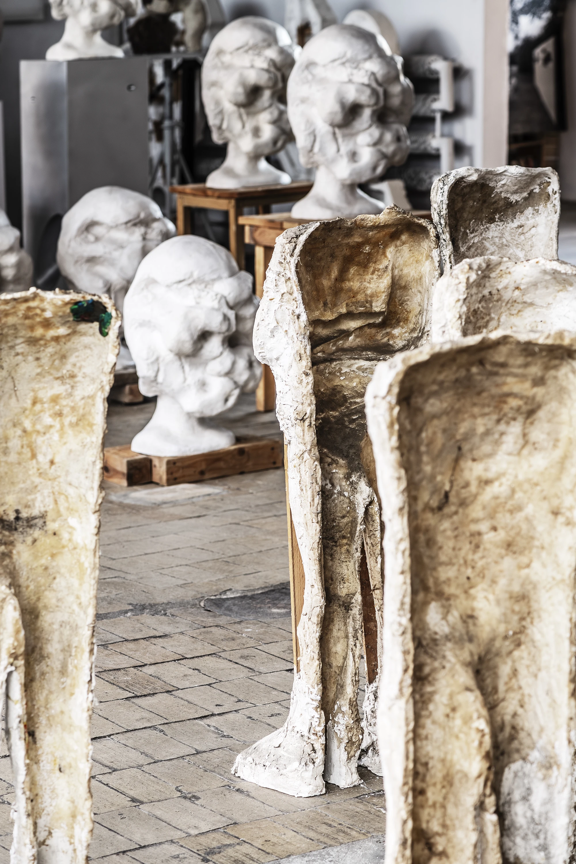 Magdalena Abakanowicz / Wanda Czełkowska by Abakanowicz Foundation, photographed by Norbert Piwowarczyk — headless burlap and plaster figures lit by a projected archival film of a 1970s urban crowd.