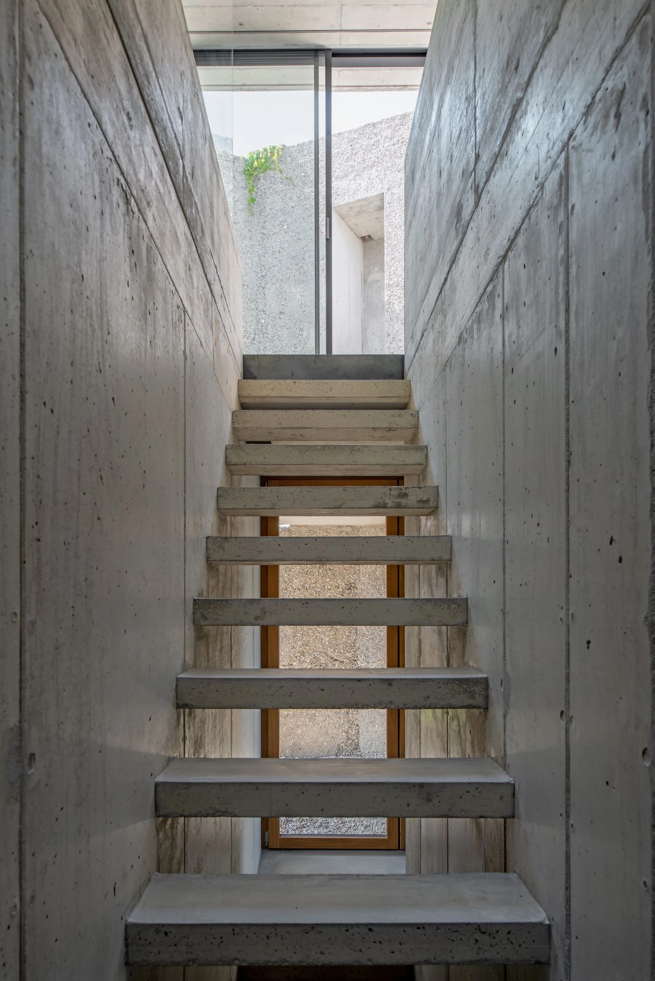 New House in San Nazzaro by Wespi de Meuron Romeo, photographed by Giacomo Albo — the external staircase carved into a thick wall climbing to the roof terrace.