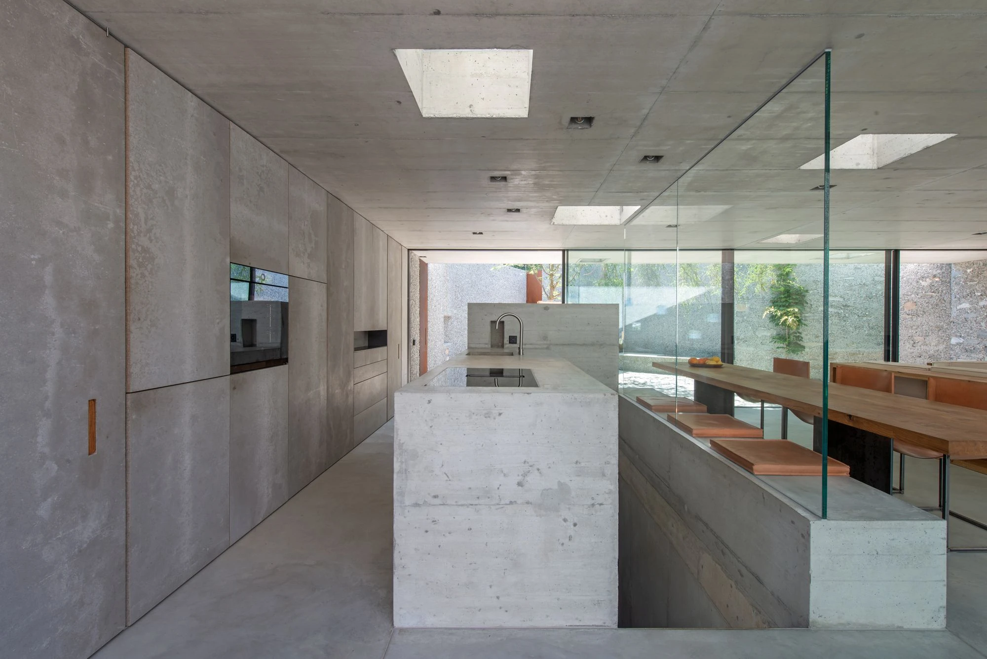 New House in San Nazzaro by Wespi de Meuron Romeo, photographed by Giacomo Albo — kitchen detail with stainless tap and the smooth concrete worktop.