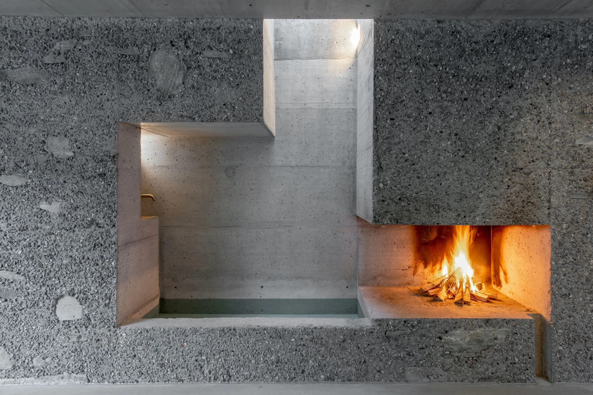 New House in San Nazzaro by Wespi de Meuron Romeo, photographed by Giacomo Albo — looking out from the dining room toward the mountain-side courtyard.