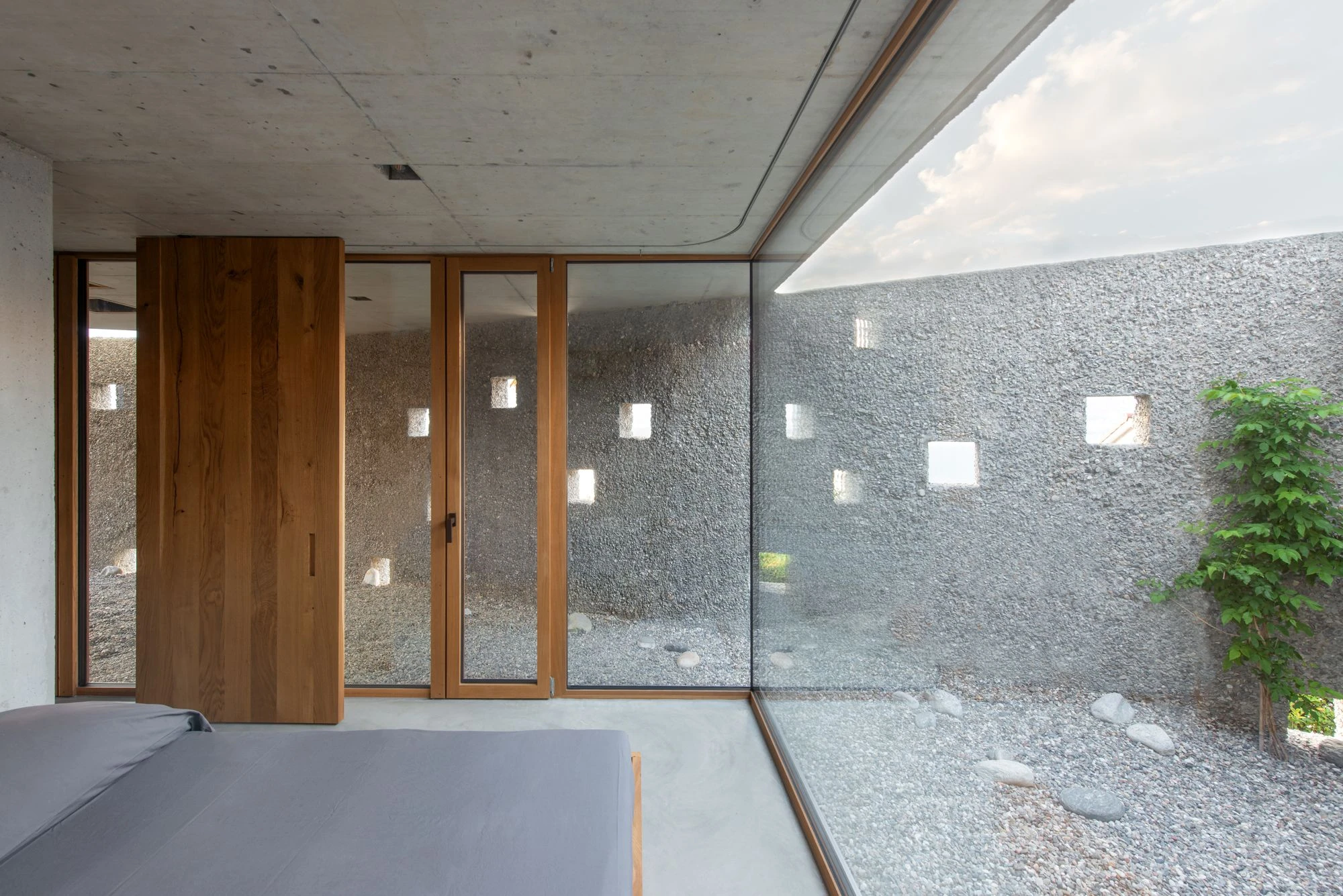 New House in San Nazzaro by Wespi de Meuron Romeo, photographed by Giacomo Albo — interior detail of an oak window jamb set into the concrete wall.