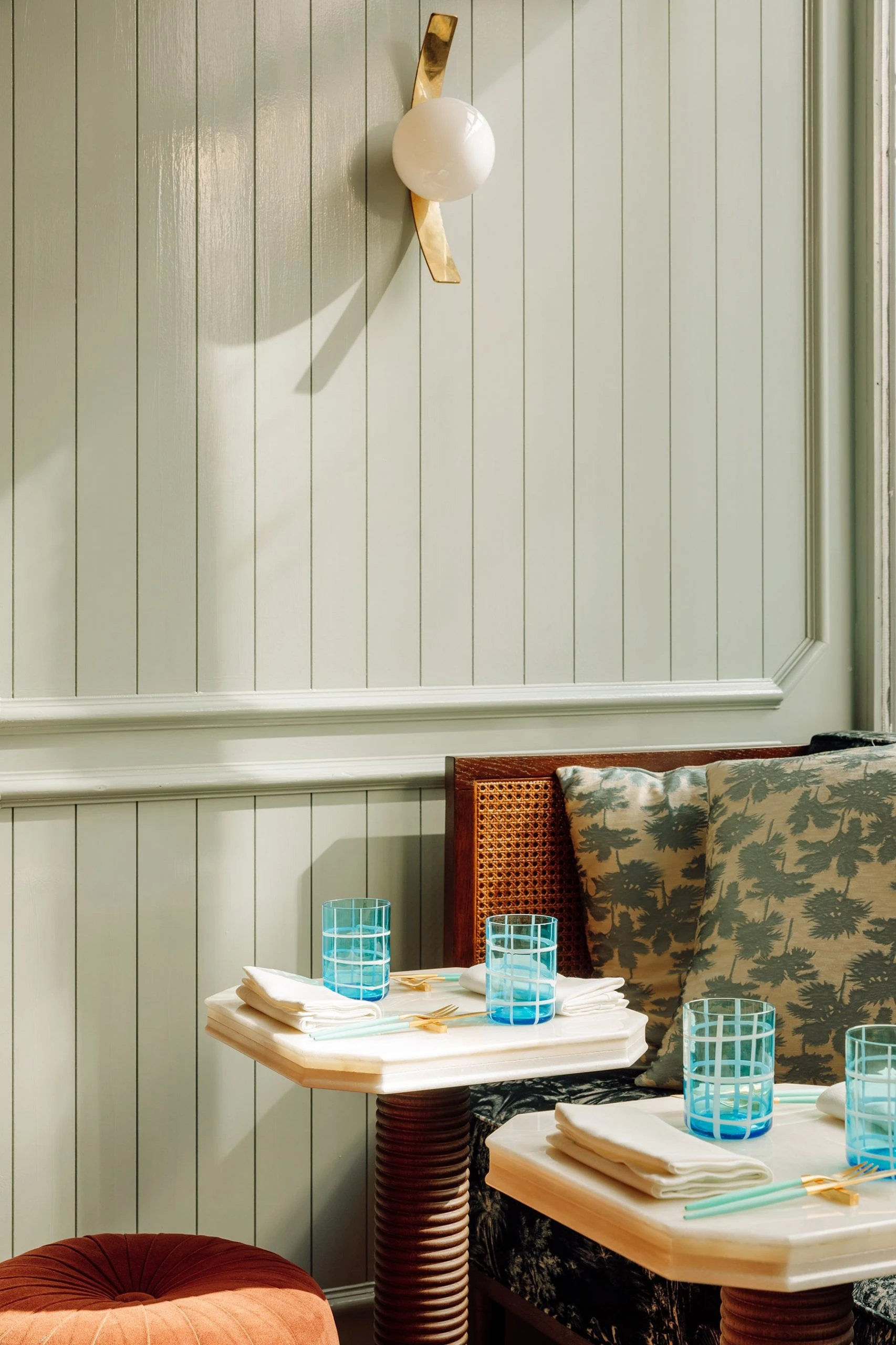 The Ivens by Lázaro Rosa-Violan, photographed by Francisco Nogueira — Crudo Bar with sage tongue-and-groove panelling, brass globe sconce and cobalt tumblers.