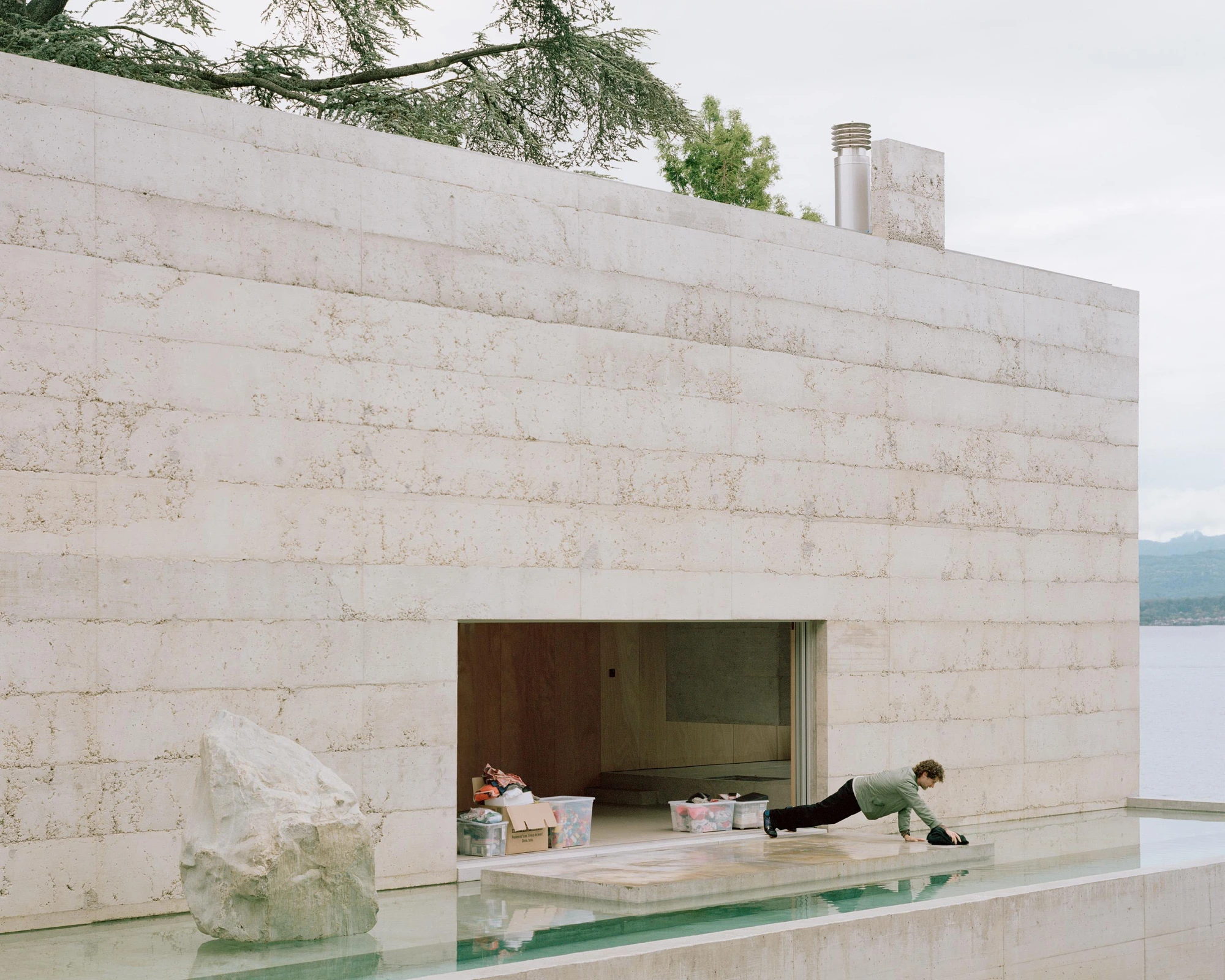 Villa M by Leopold Banchini Architects, Geneva Switzerland, board-formed concrete villa, reflecting water basin, Lake Geneva, Rory Gardiner