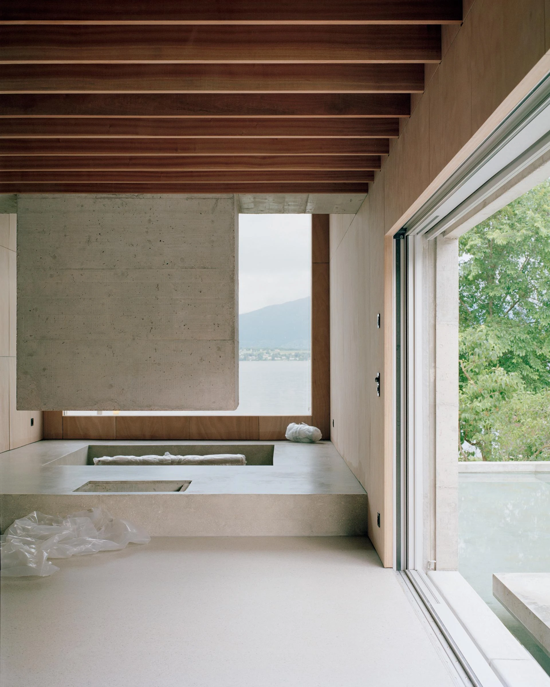 Villa M by Leopold Banchini Architects, Geneva Switzerland, board-formed concrete villa, reflecting water basin, Lake Geneva, Rory Gardiner