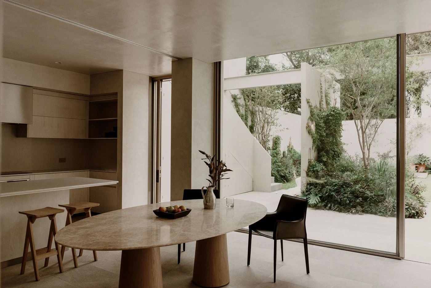 Barrancas by PPAA, photographed by Luis Garvan — pale timber joinery with handleless cabinetry and a professional tap in the kitchen, the surfaces kept to a single quiet tone throughout.