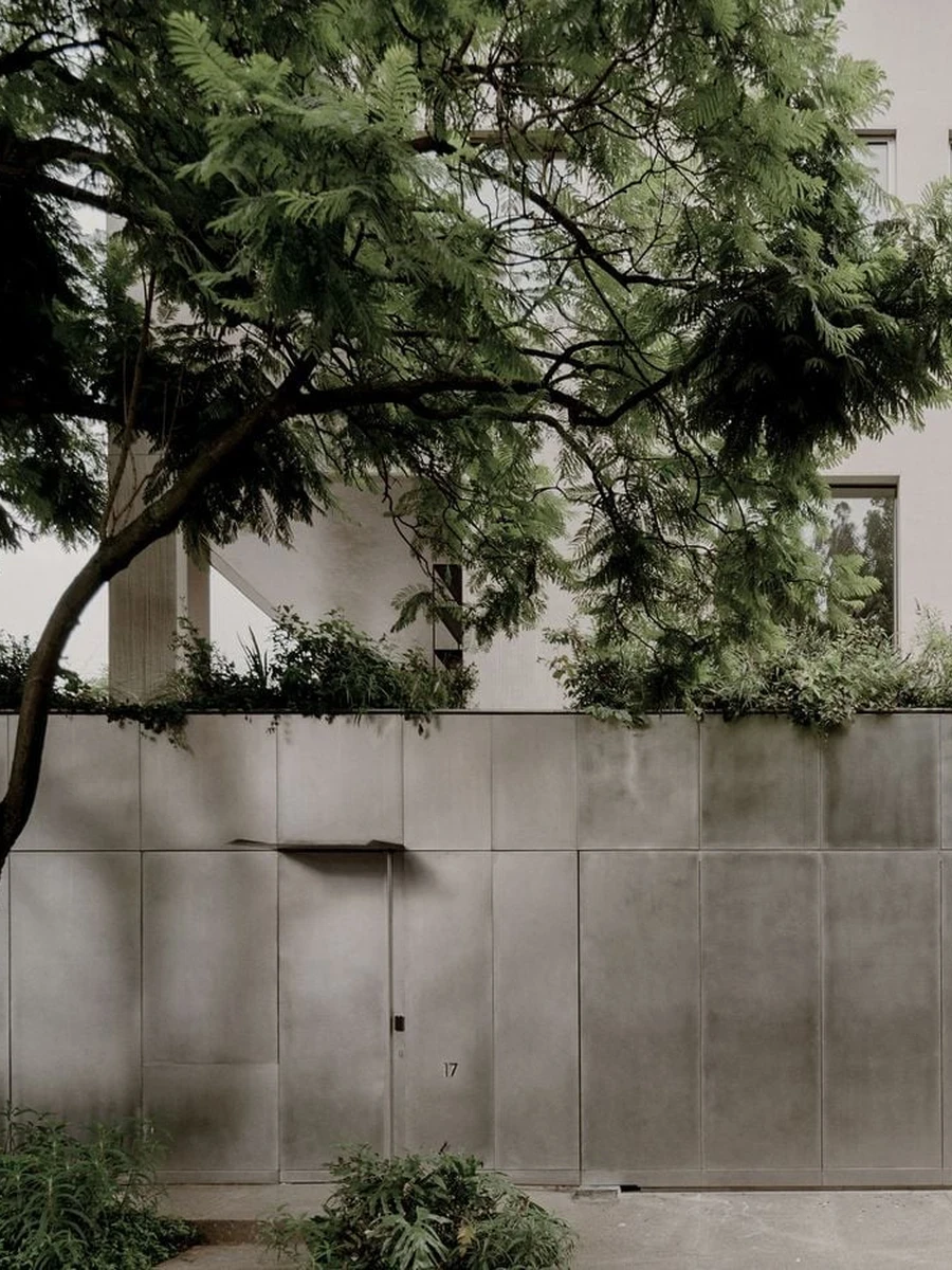 Barrancas by PPAA — Mexico City, Mexico: Where most houses assert a face to the street, PPAA's Barrancas in Mexico City carves absence into the volume itself, a displaced plaster cube that leaves a loggia where the mass should be.