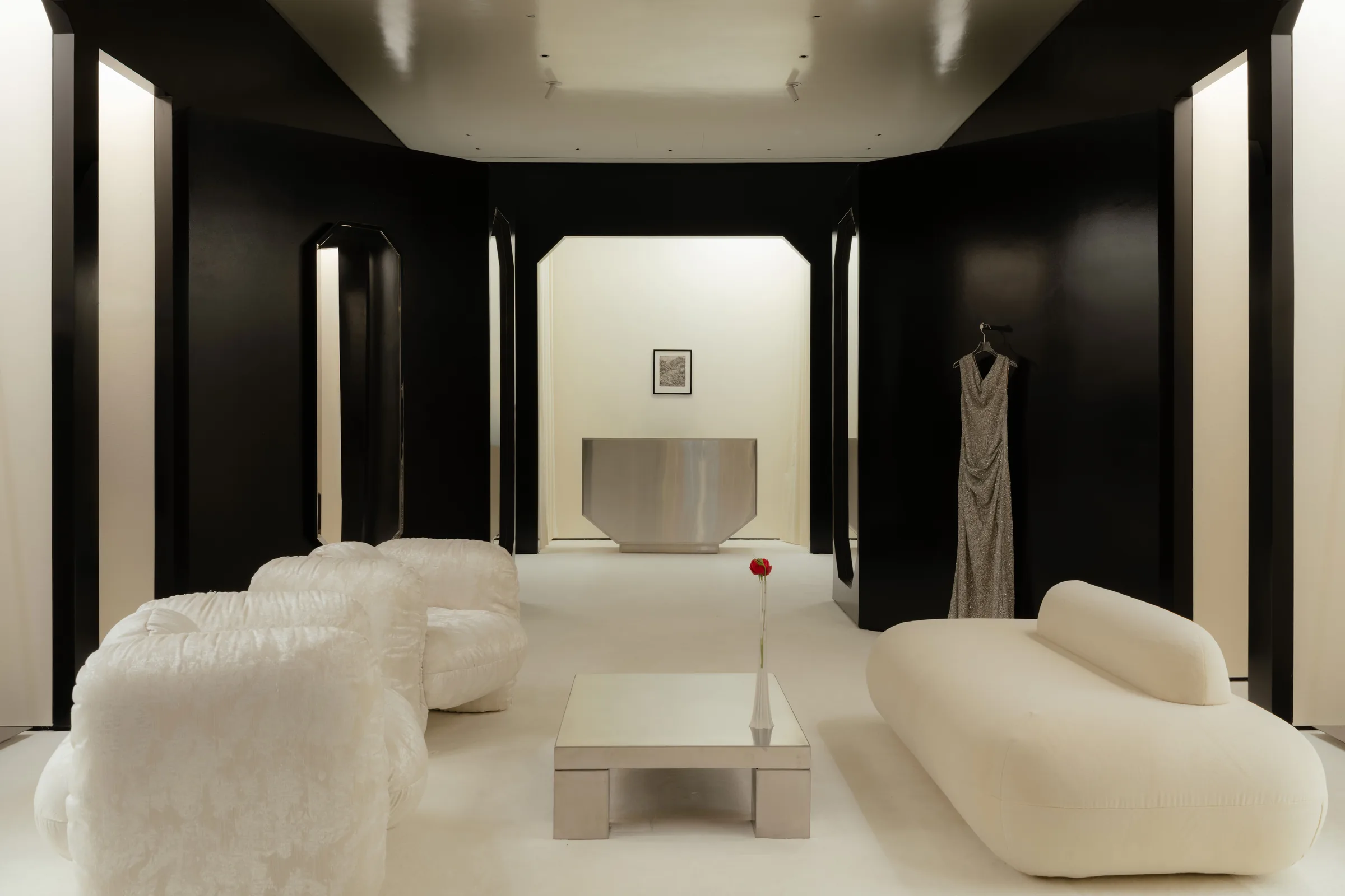 Roses Lace by EDXXKAT — Wide elevation of the lounge: three octagonal black mirrors and two illuminated niches line the back wall, four long-pile white shearling sofa-blocks gather around a low coffee table, the recessed ceiling above edged in soft…