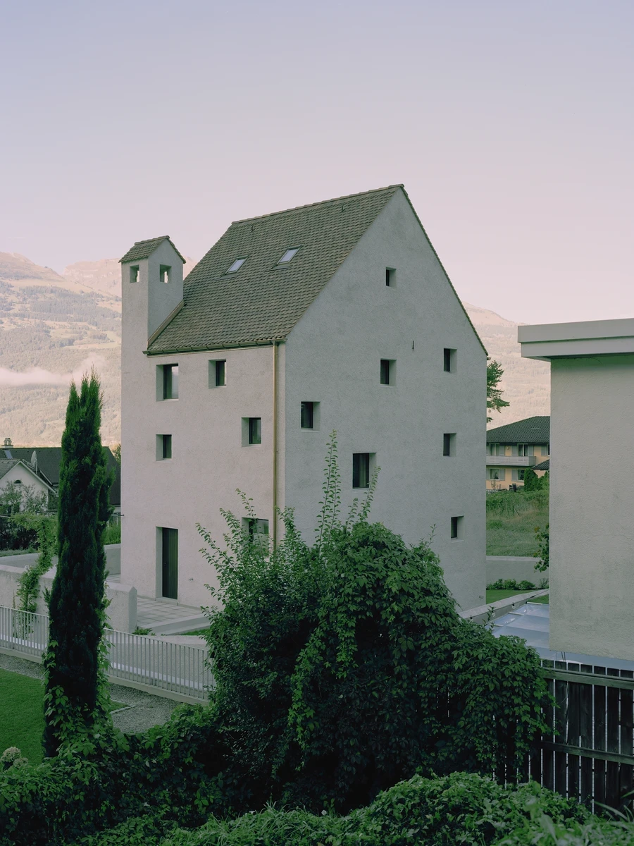 Tower house Vaduz by Schreiber Architekten — Vaduz, Liechtenstein: Beside the historic Red House in Vaduz, the capital of Liechtenstein, Schreiber Architekten raise Tower house Vaduz, a five-story tower whose shell and pitched roof are cast as one monolit