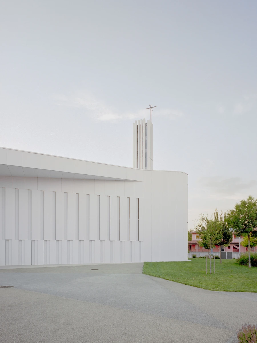 Church S. Pietro da Verona by Nexus Associati, photographed by Julian Holzwarth — monolithic white concrete parish church where variable-geometry columns transform southern light, Verona, Italy