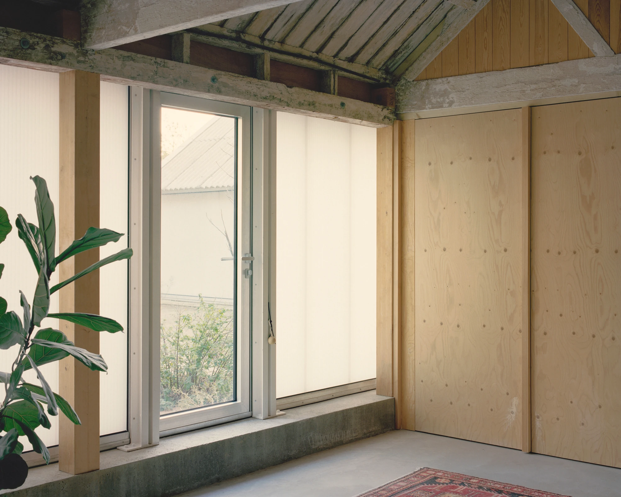 The Old Byre by Gianni Botsford Architects, photographed by Willem Pab — conversion of two farm buildings into a home and artist residency on the Isle of Wight, United Kingdom
