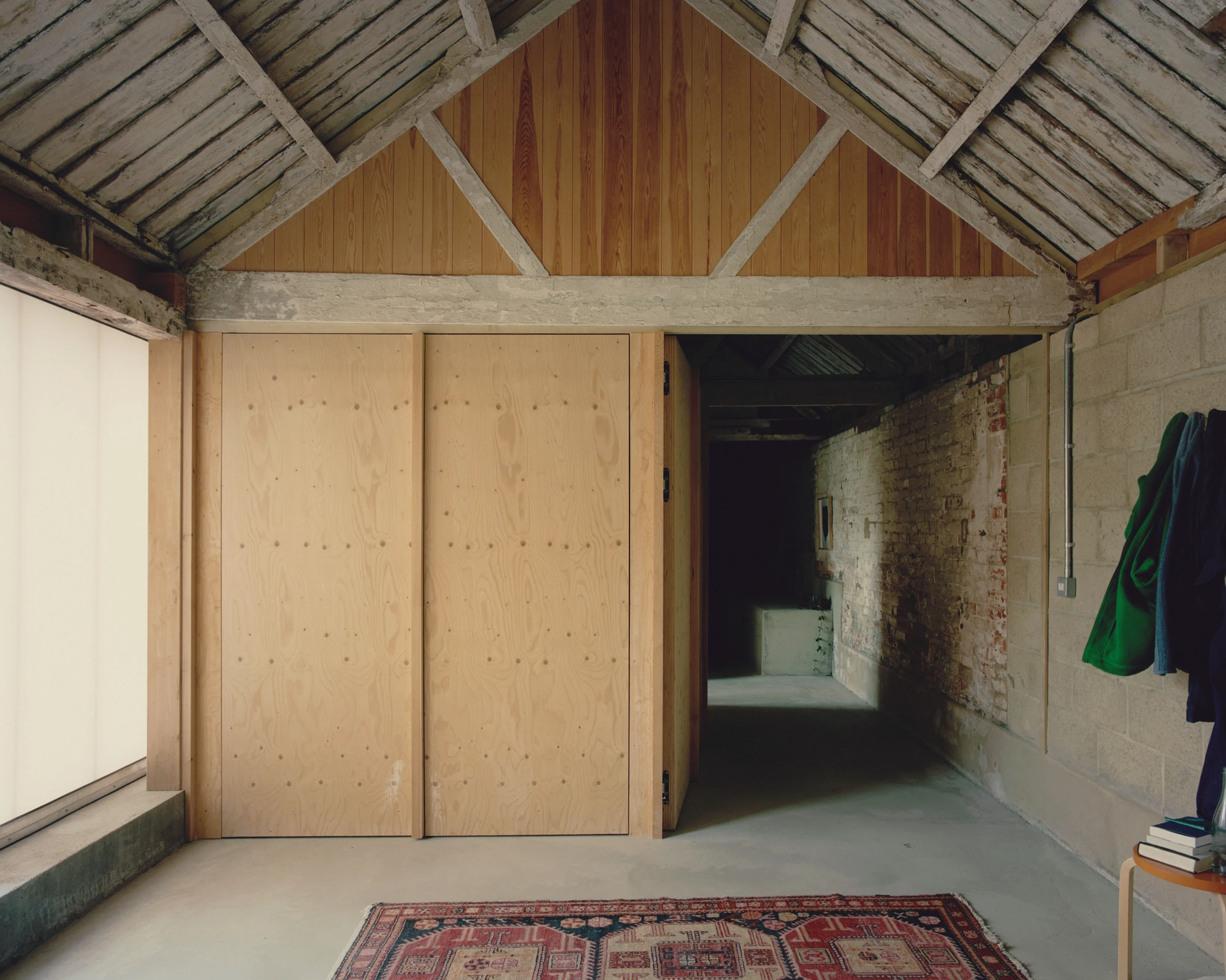 The Old Byre by Gianni Botsford Architects, photographed by Willem Pab — conversion of two farm buildings into a home and artist residency on the Isle of Wight, United Kingdom