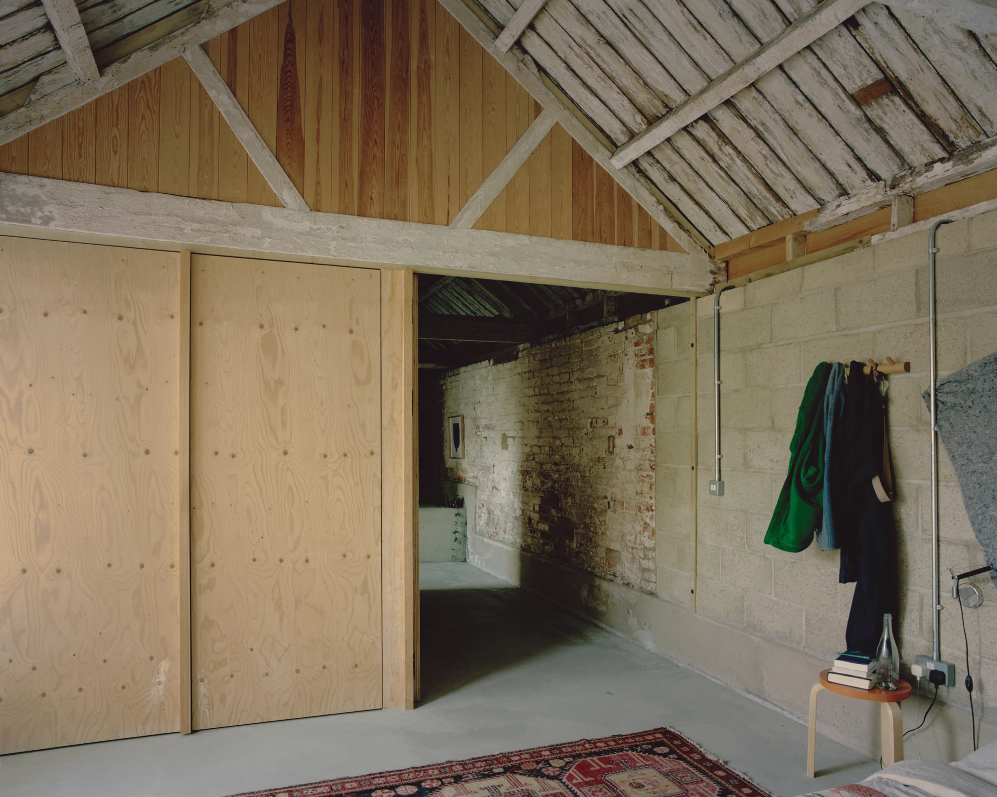 The Old Byre by Gianni Botsford Architects, photographed by Willem Pab — conversion of two farm buildings into a home and artist residency on the Isle of Wight, United Kingdom