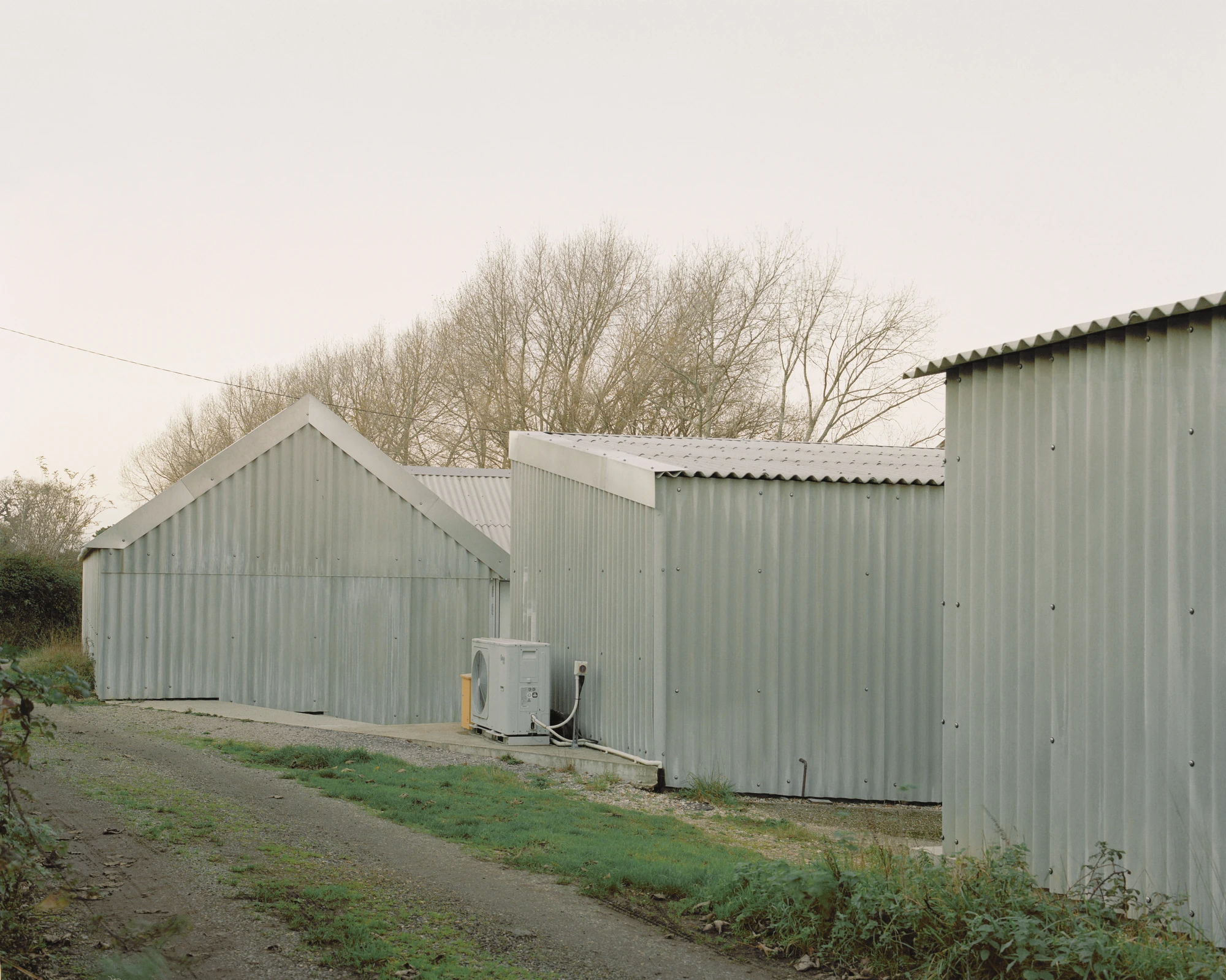 The Old Byre by Gianni Botsford Architects, photographed by Willem Pab — conversion of two farm buildings into a home and artist residency on the Isle of Wight, United Kingdom