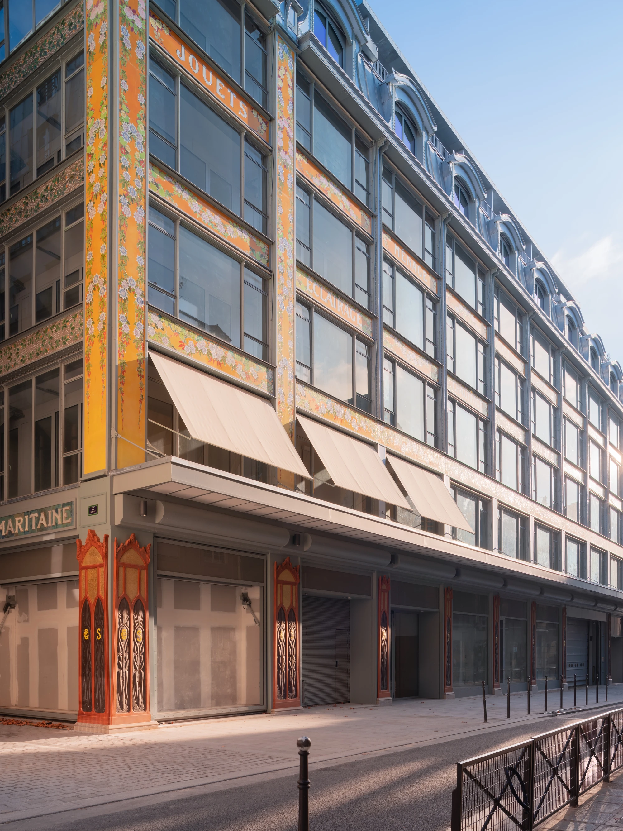 La Samaritaine by SANAA, photographed by Jared Chulski — The restored Art Nouveau shopfront on the side street, enamelled floral panels and cream awnings over the arcade.