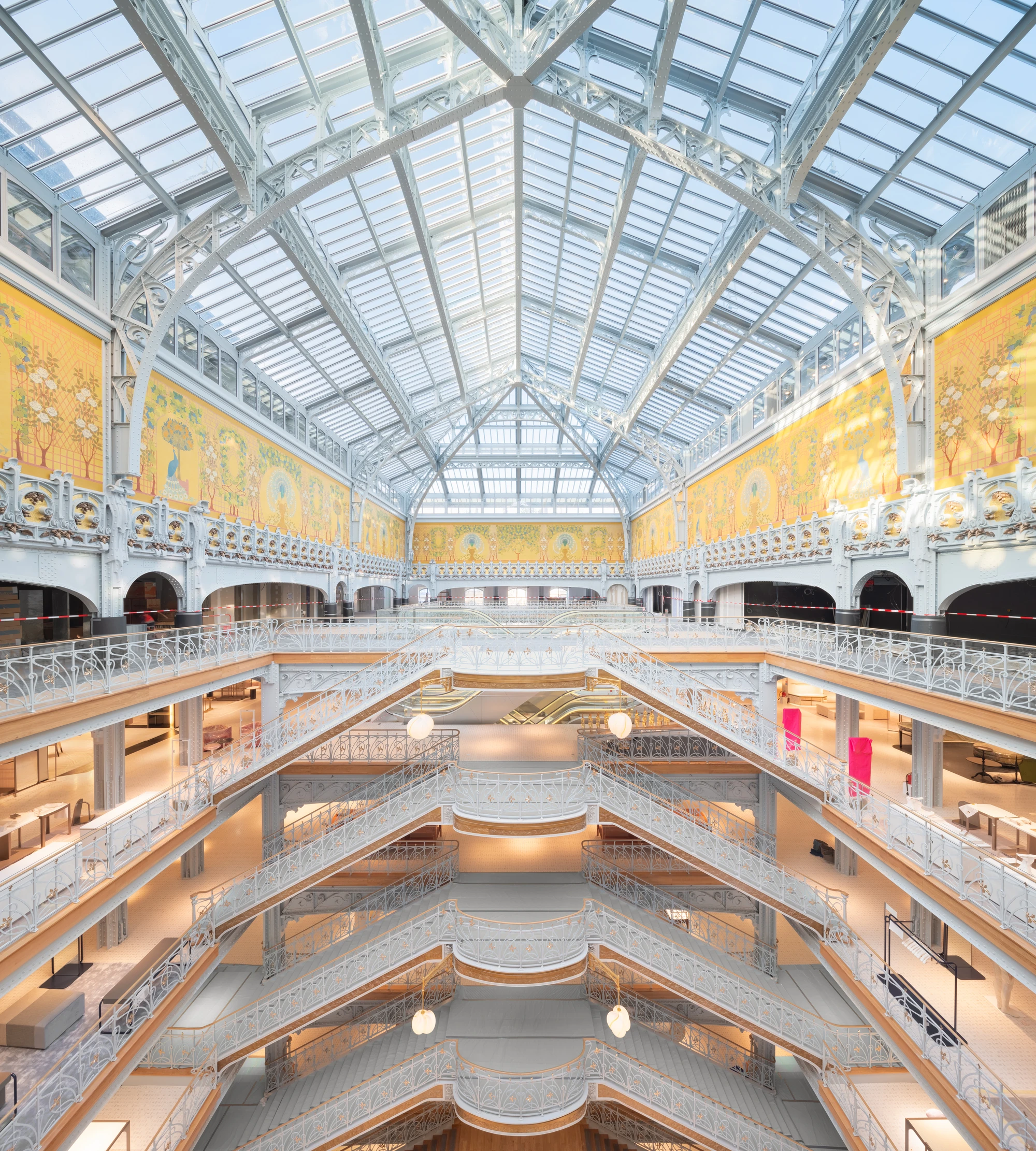 La Samaritaine by SANAA, photographed by Jared Chulski — The full atrium from the top floor, tiers of white iron balconies stacked beneath the frescoed crown.