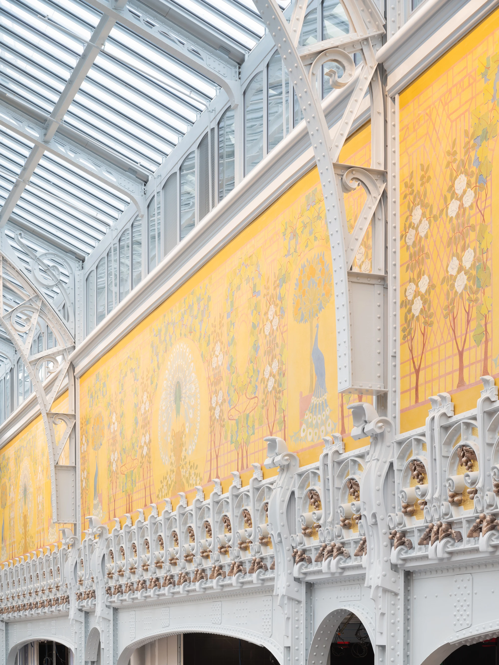 La Samaritaine by SANAA, photographed by Jared Chulski — A close view of the restored frieze, painted peacocks and blossom over white cast-iron balustrade detailing.