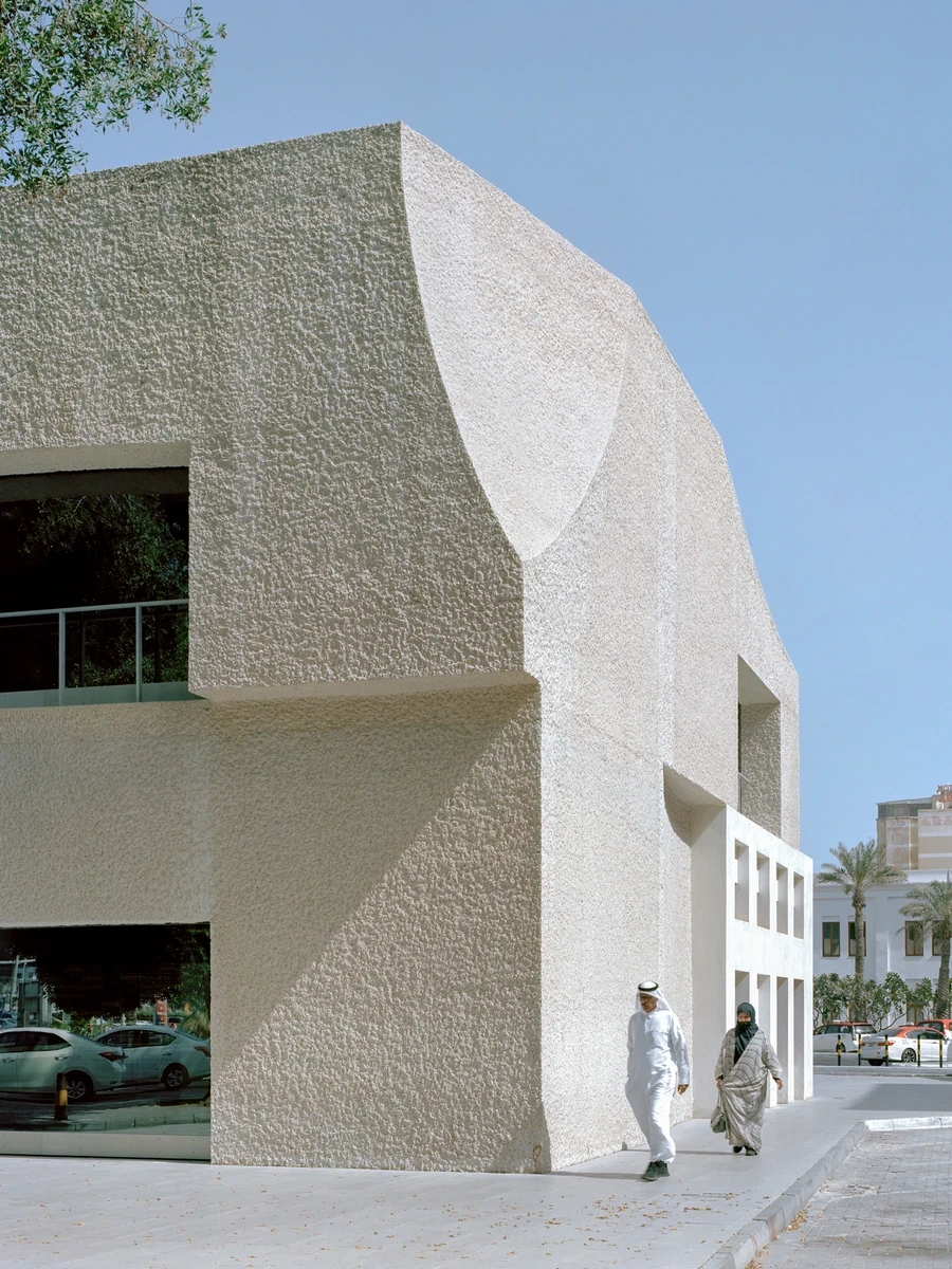 21 Customs House Post Office by Studio Anne Holtrop — Manama, Bahrain: On the square at Bab Al Bahrain in Manama, Studio Anne Holtrop finishes the 1937 Customs House by adding a third volume of white hand-hammered concrete that stops short at the corners,