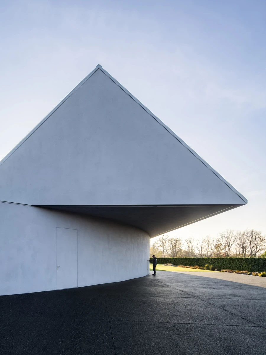 Yaw House by Robert Konieczny KWK Promes — Beskid Mountains, Poland: On a steep plot in Poland's Beskid Mountains, Robert Konieczny KWK Promes takes a classic gabled house and rotates it into the slope, so its roof peels away from the hill and dissolves i