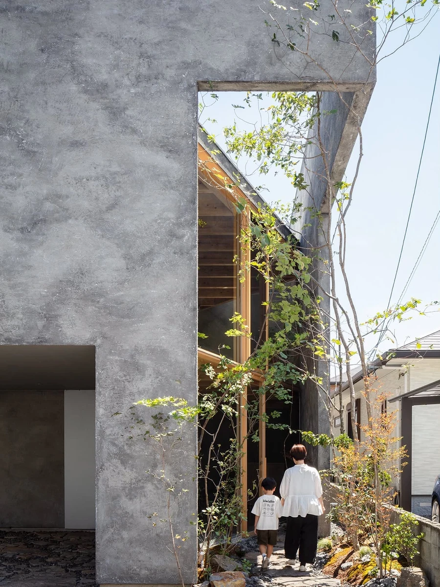 NesT by mA-style architects — Japan: On a 30-tsubo lot in a Japanese neighbourhood, boxed in on three sides, mA-style architects cut slots into the roof, walls and floors of NesT to draw light through a house shared with a confectionery shop.