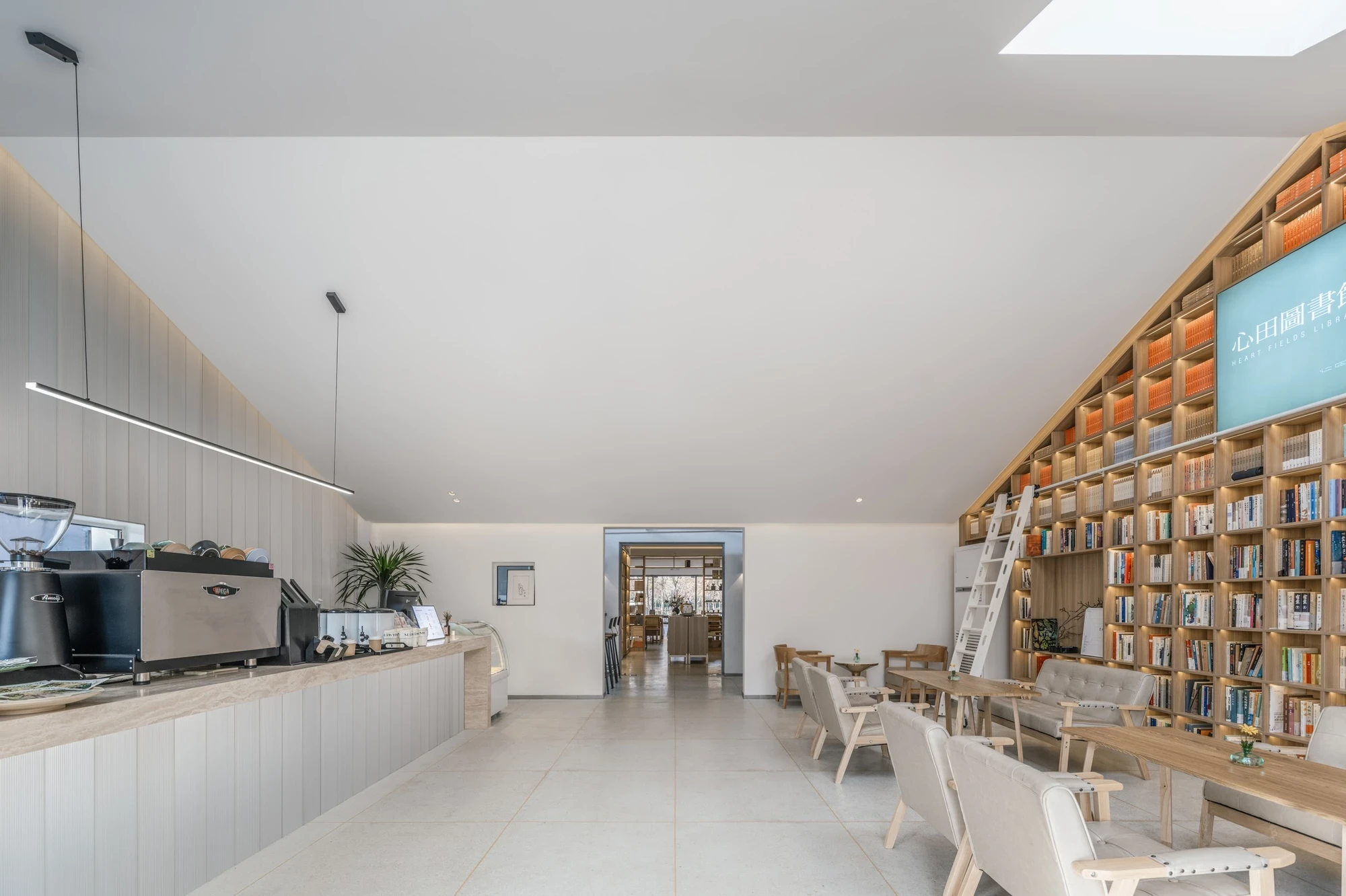 Heart Fields by Wutopia Lab, photographed by CreatAR Images — at dusk the ground floor glows through full-height glazing onto a garden set with tables and chairs.