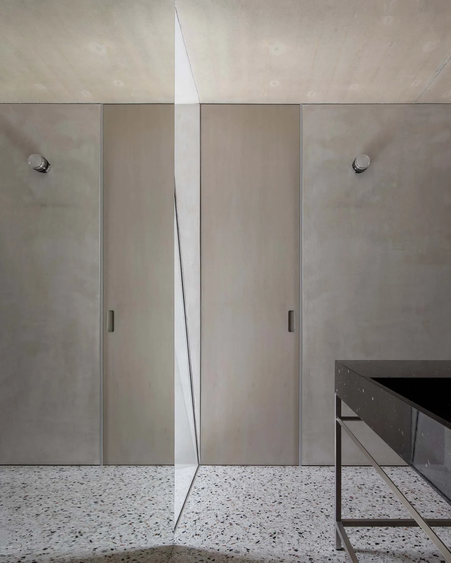 Casa Azul by extrastudio, photographed by Mikael Olsson — a pale plastered upper room lit by a diagonal skylight cut into the sloping concrete ceiling.