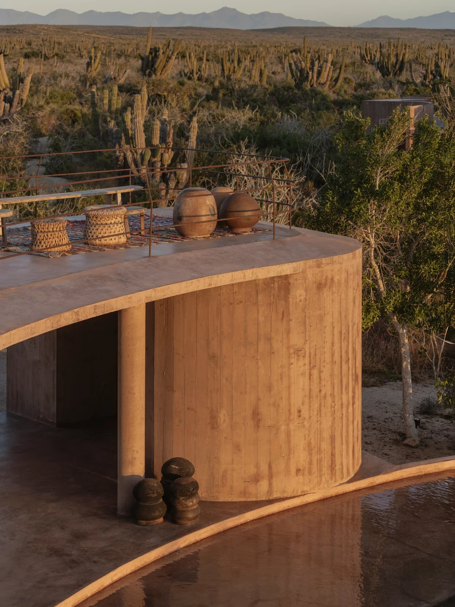 Nereidas by studiofont, photographed by @alberstudio — woven baskets and clay vessels sit on a curved concrete roof terrace above the cactus plain at golden hour.