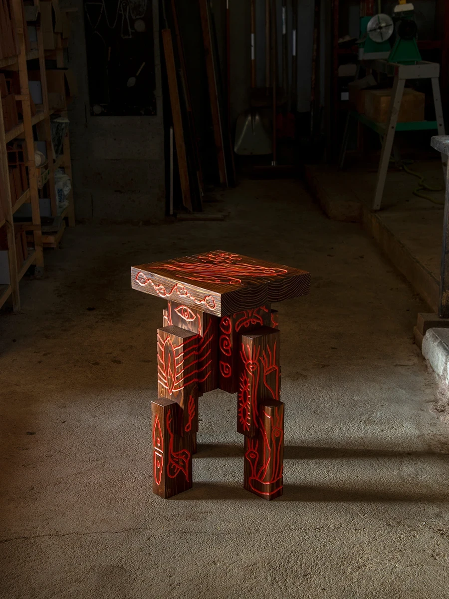 Les Rhizopodes by Barreau Charbonnet — Nantes, France: At Galerie Mira in Nantes, Barreau Charbonnet carves Les Rhizopodes, solid timber blocks cut in blunt brutalist slabs and grooved with cell-biology motifs that glow in the dark.