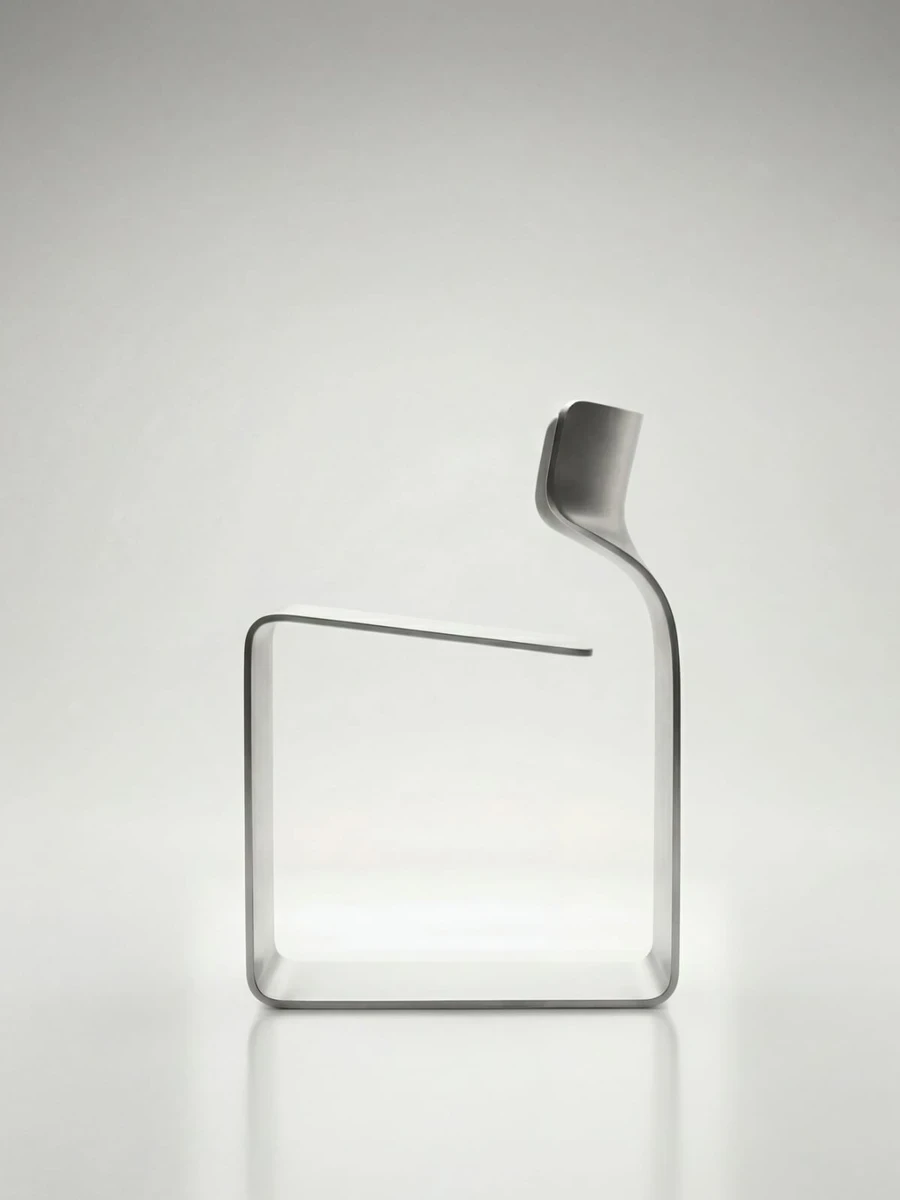 ZERO Chair by Davide Bozzo: With ZERO Chair, Davide Bozzo bends a single ribbon of metal into base, seat and backrest at once, a cantilevered form held together by nothing, because there is no weld, no bolt and no joint to hold.